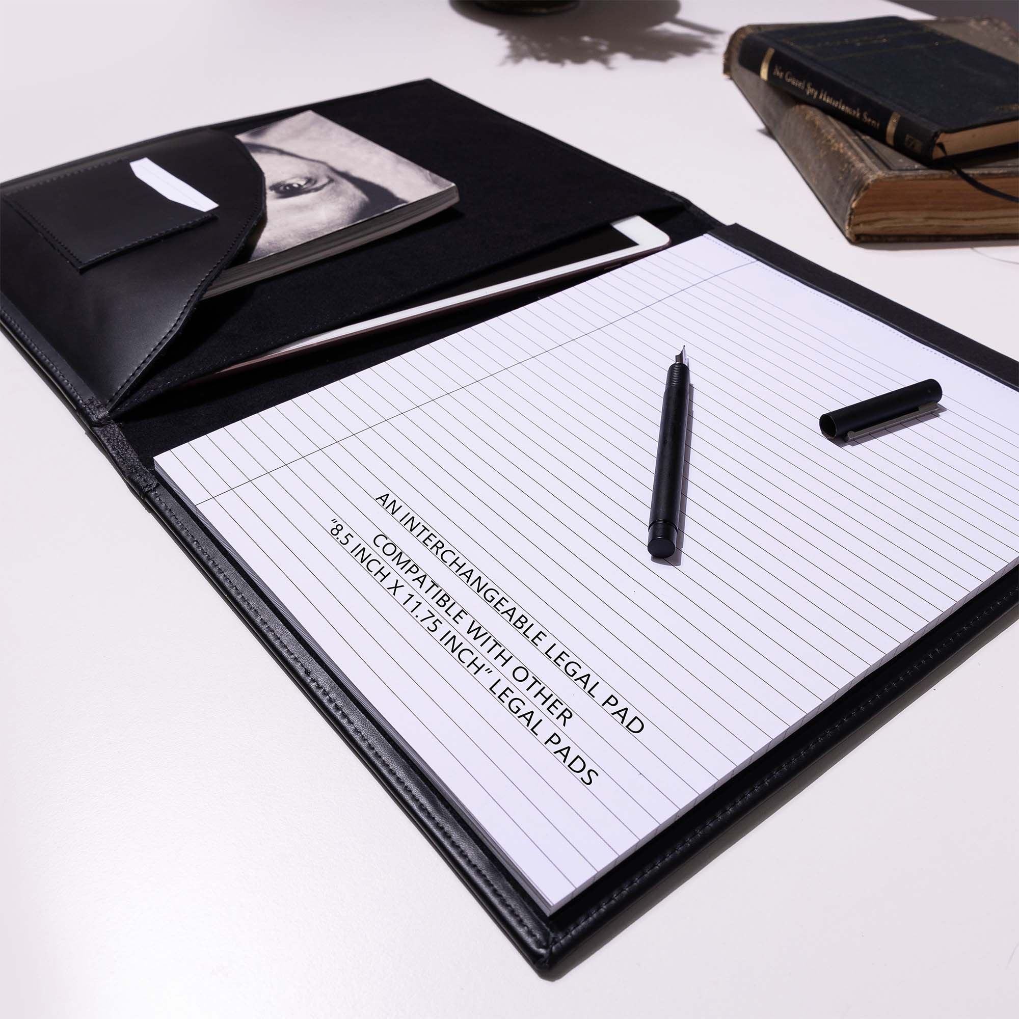 Black Leather A4 padfolio on the deskwith pen  #color_black