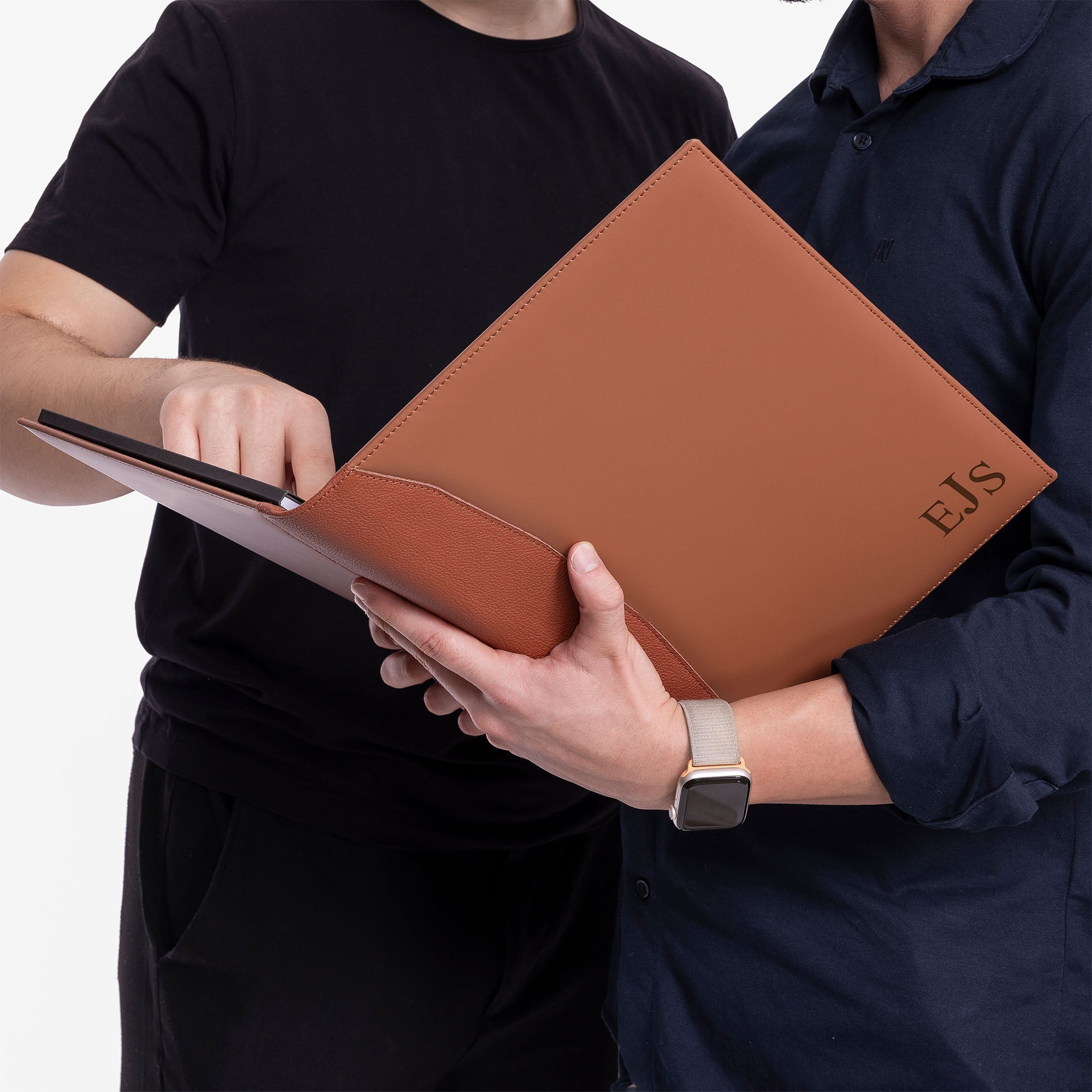 Model holding personalized Brown Leather A4 padfolio while other men writing