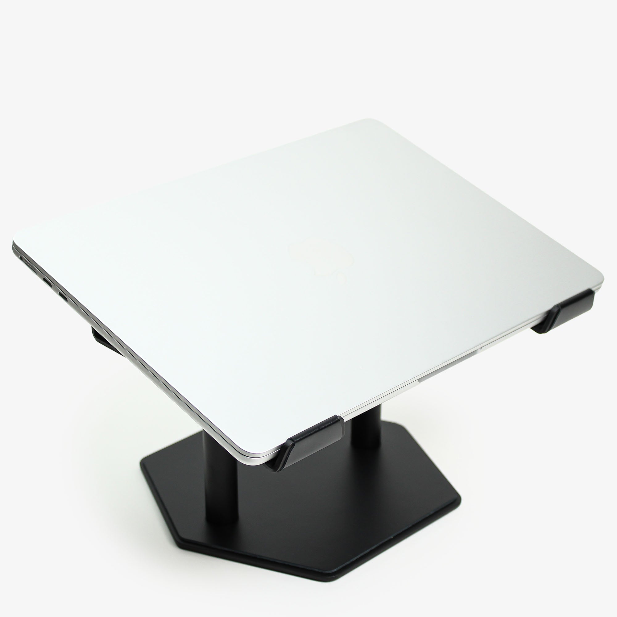 Front view of the black leather and aluminum laptop riser on a desk