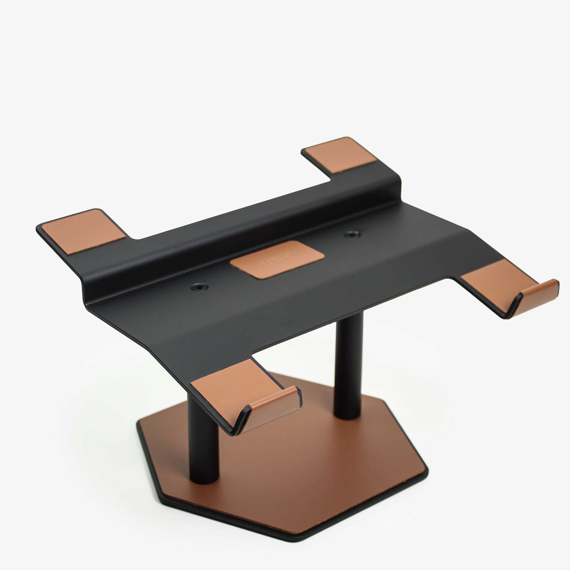 Front view of the chestnut leather and aluminum laptop riser on a desk