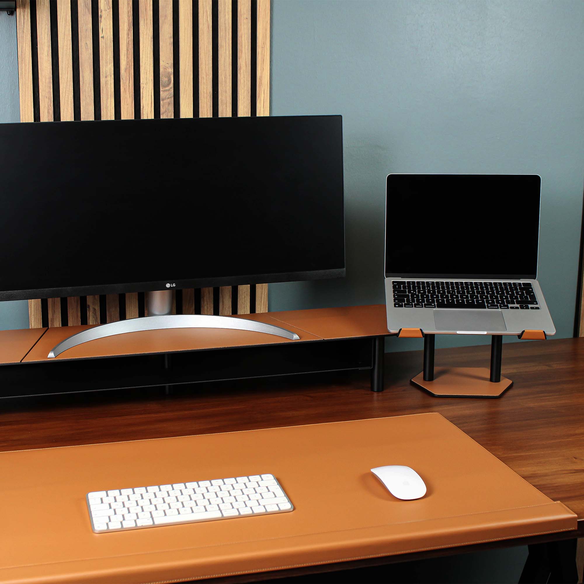 Lifestyle setup featuring the cognac laptop riser with matching accessories