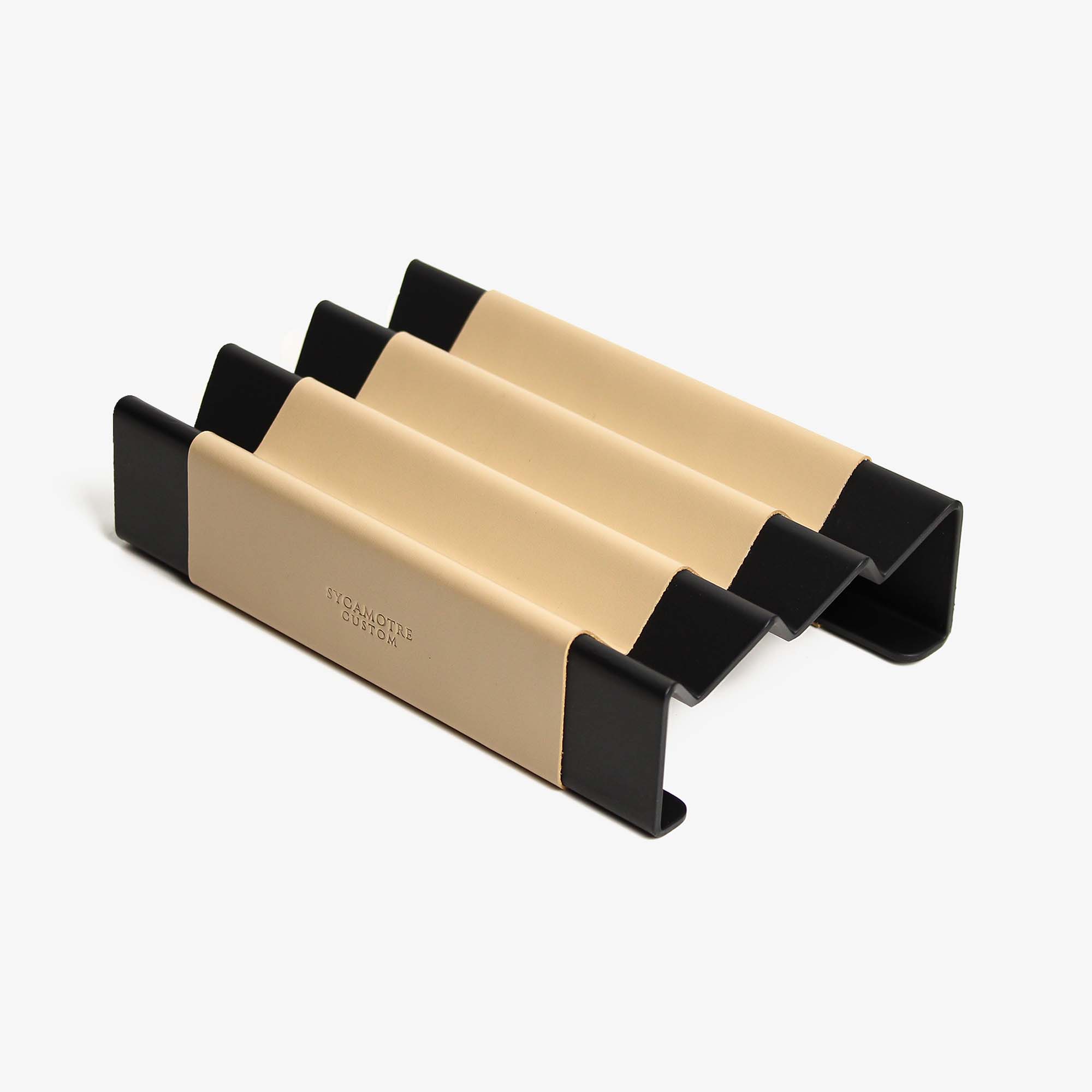 Top view of the latte leather and aluminum pen tray on a wooden desk