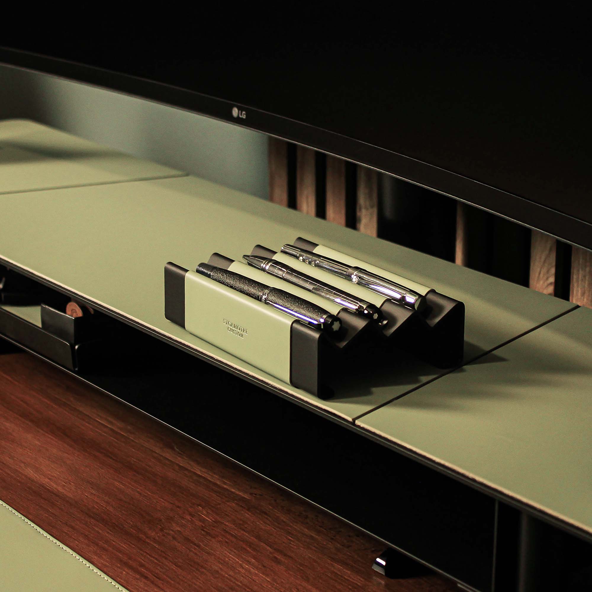 Minimalist workspace setup featuring the sage-green pen tray