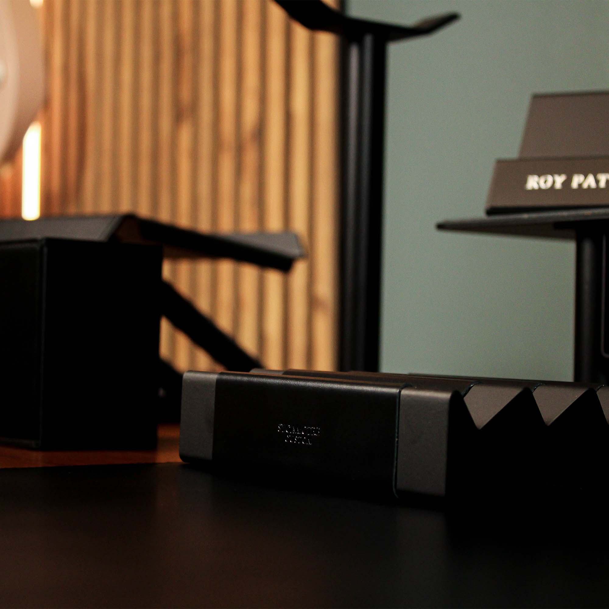 Minimalist workspace setup featuring the black pen tray