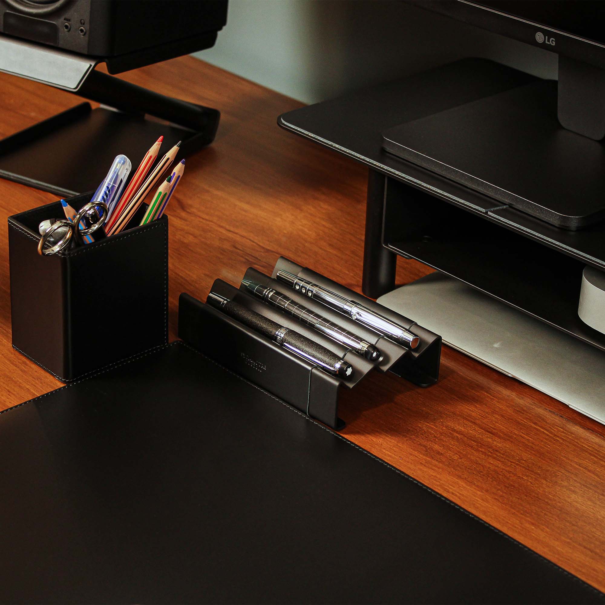 Minimalist workspace setup featuring the black pen tray