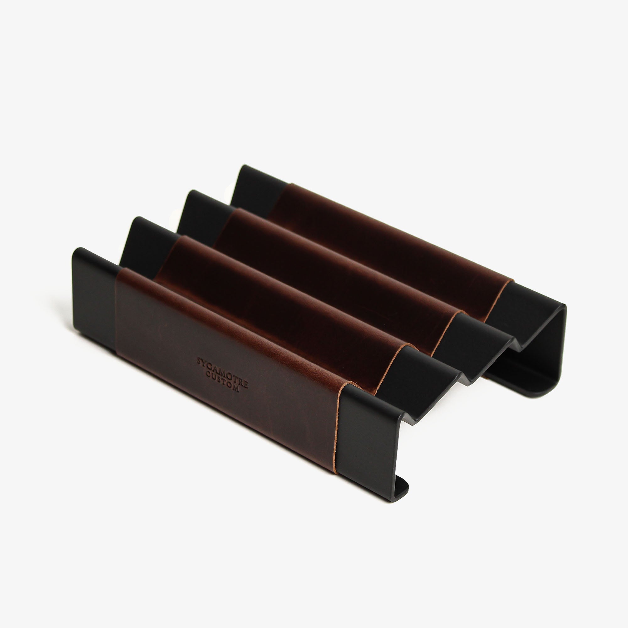 Top view of the crazy-chestnut leather and aluminum pen tray on a wooden desk #color_crazy-chestnut