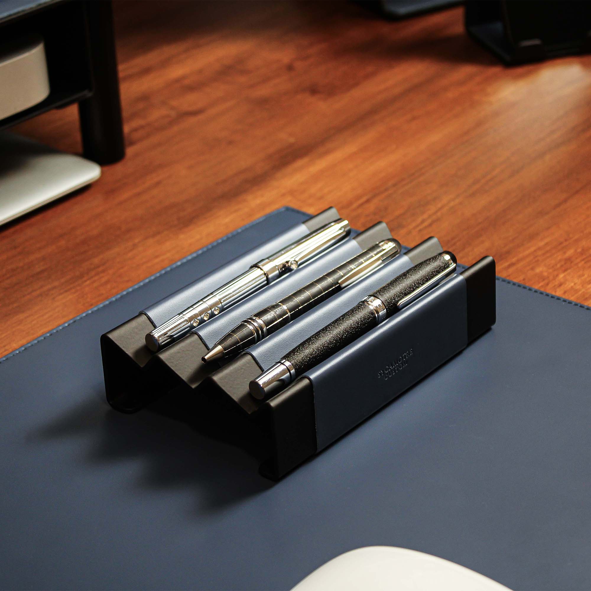 Minimalist workspace setup featuring the ocean-blue pen tray