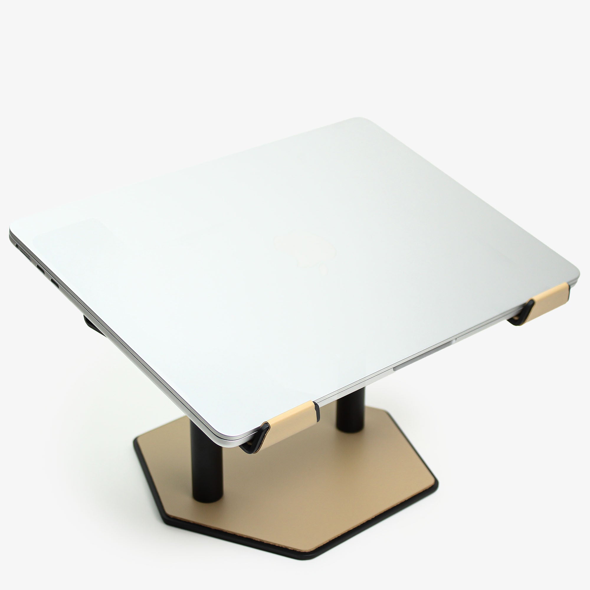 Front view of the latte leather and aluminum laptop riser on a desk  with macbook