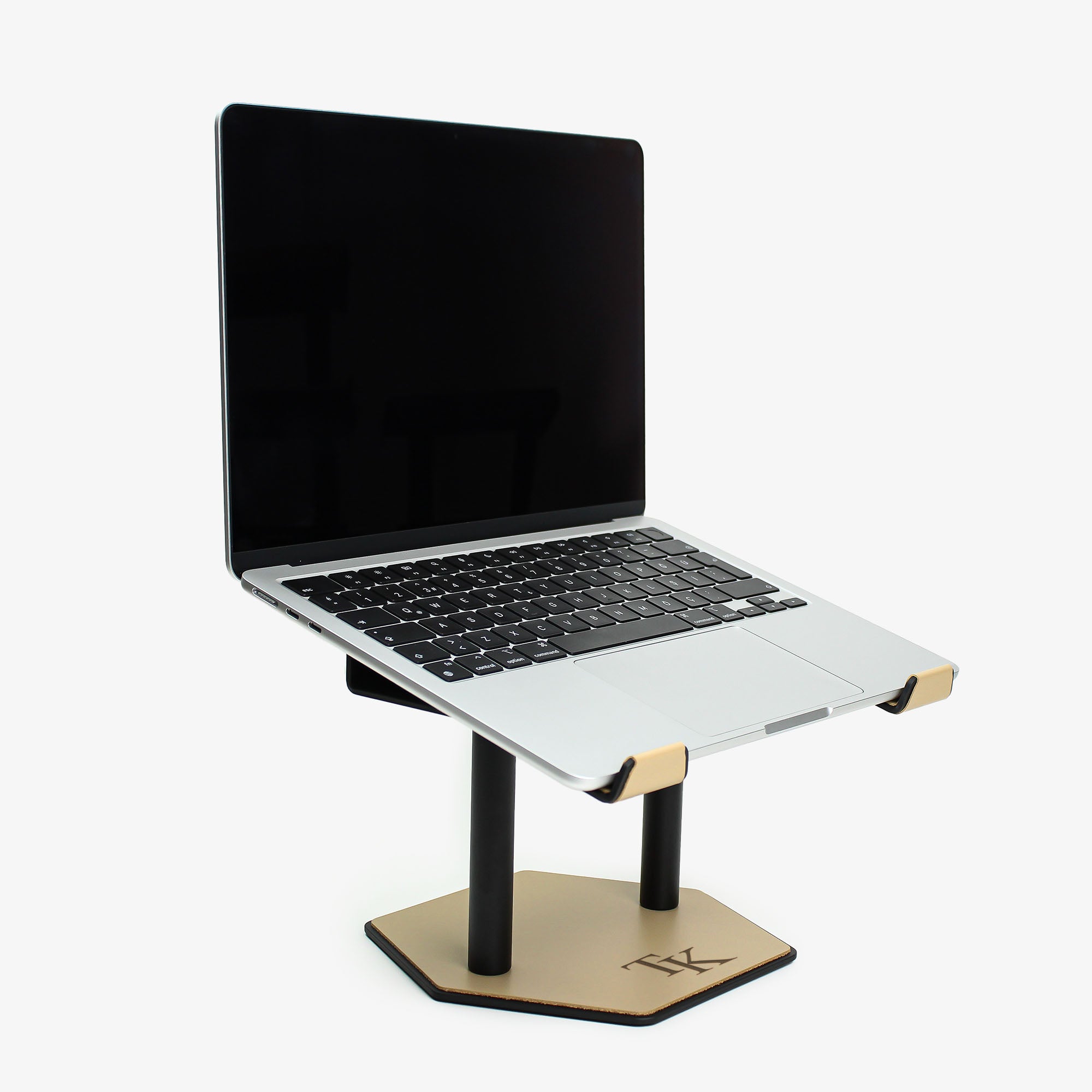 Front view of the latte leather and aluminum laptop riser on a desk with macbook