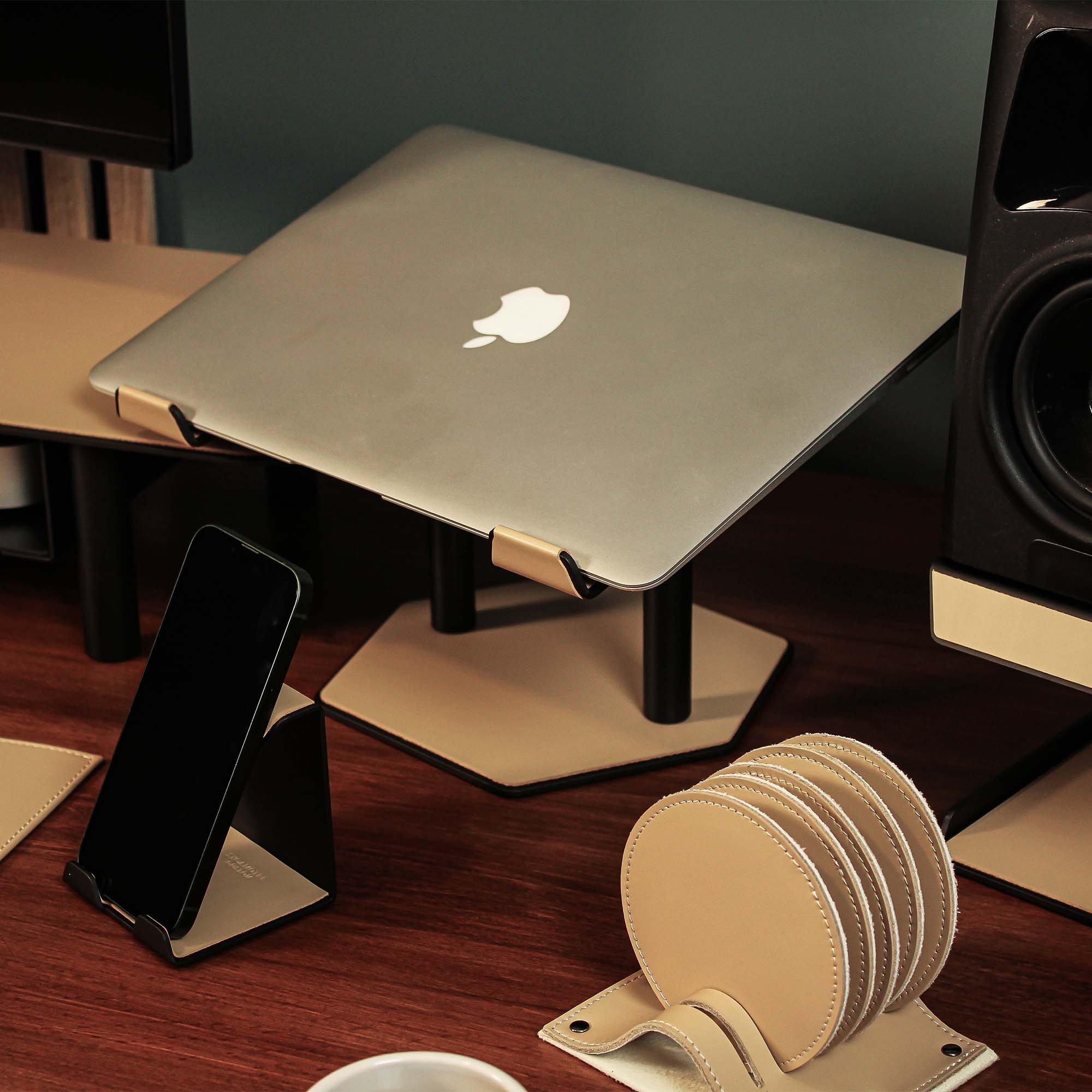 Lifestyle setup featuring the latte laptop riser with matching accessories
