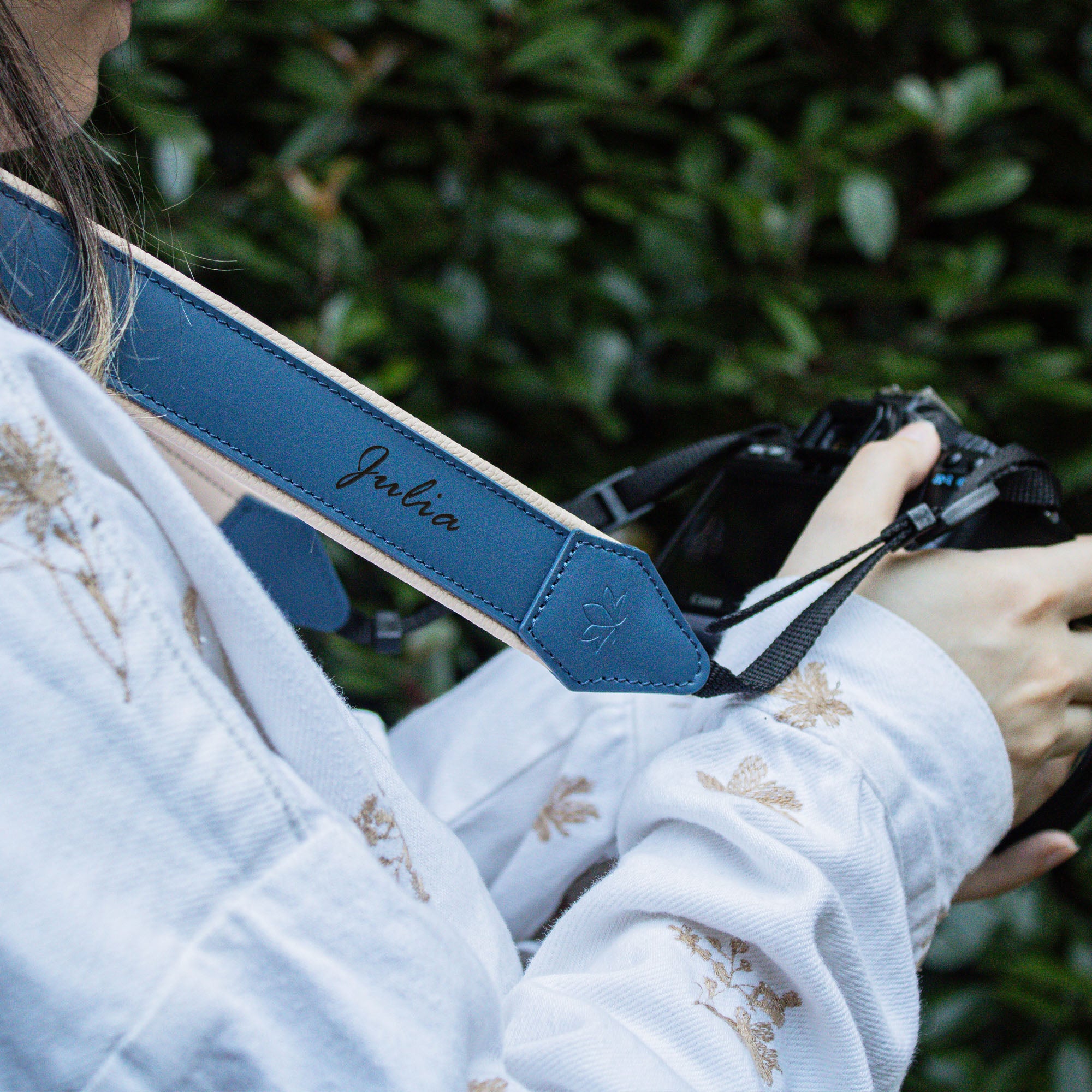 Woman using blue Personalized Leather Camera Strap With Comfortable padded and adjustable design