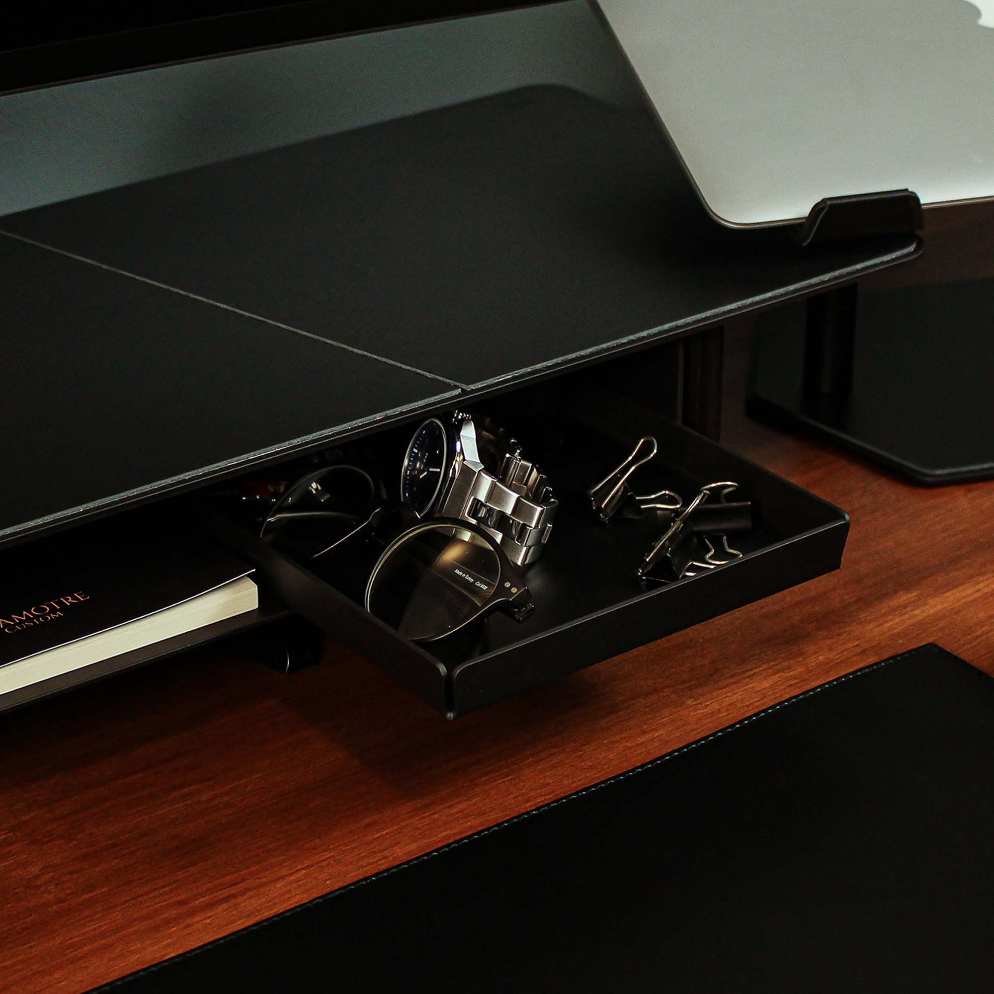 Side angle showing the sleek edges of the black valet tray