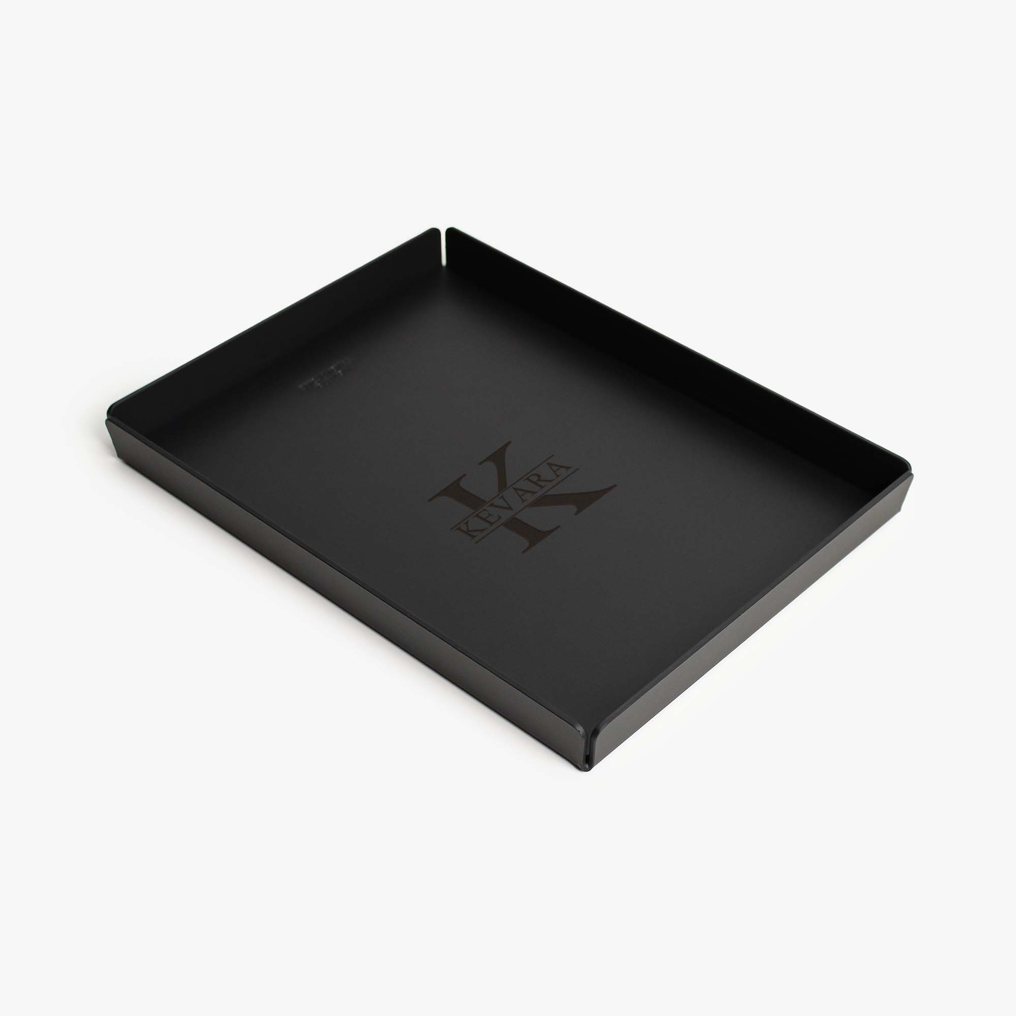 Top view of the black leather and aluminum valet tray on a wooden desk