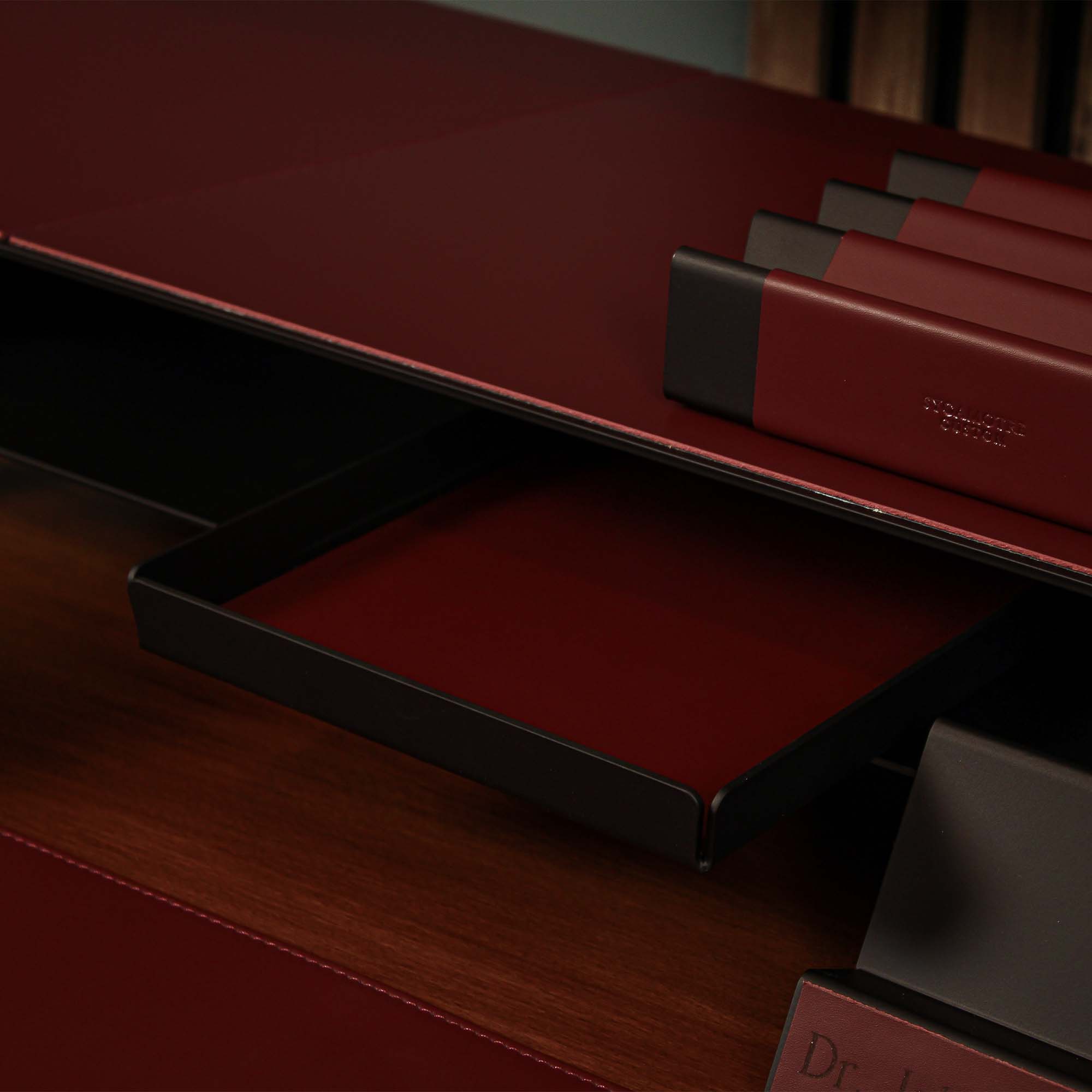 Close-up of the padded base of the burgundy valet tray for surface protection