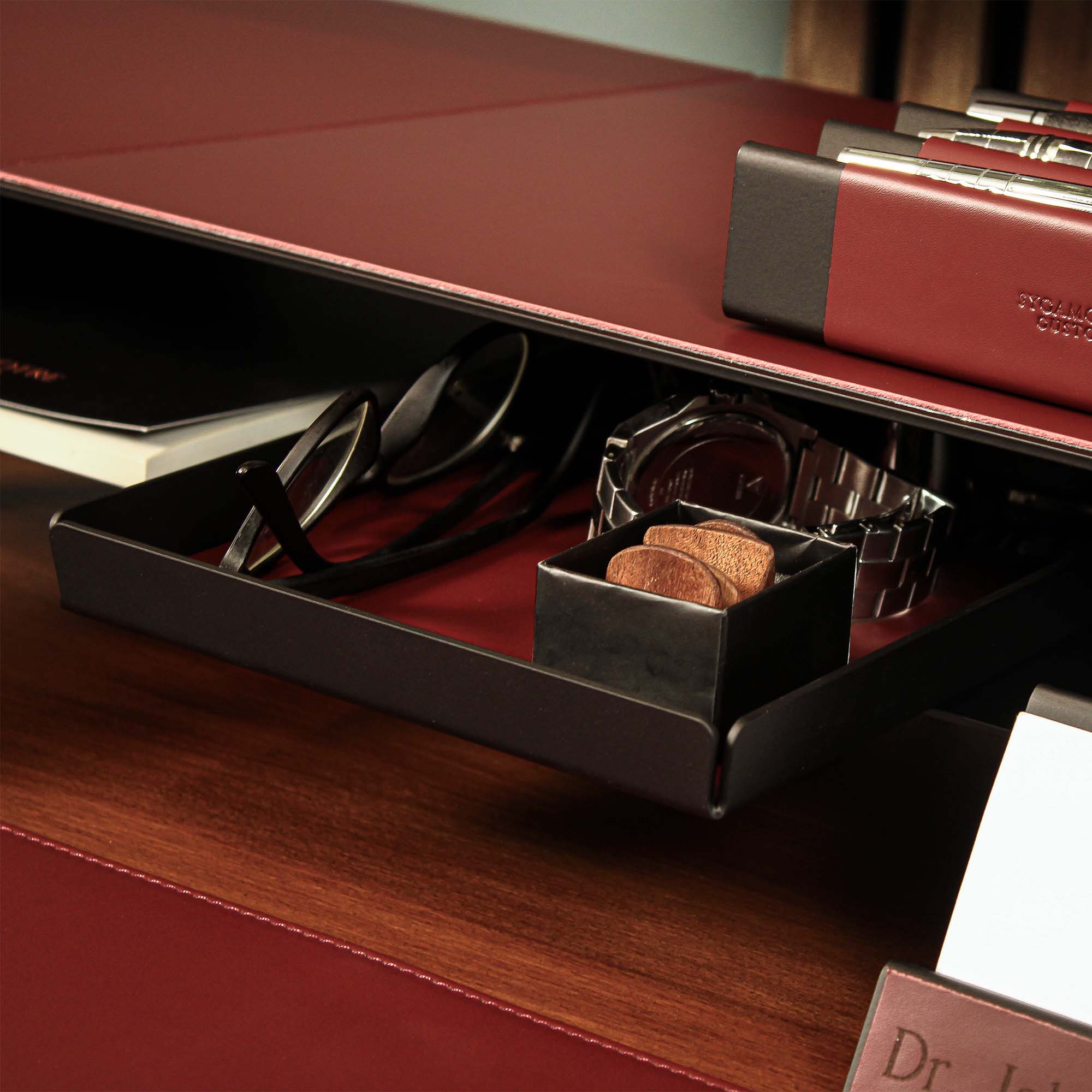 Close-up of the padded base of the burgundy valet tray for surface protection