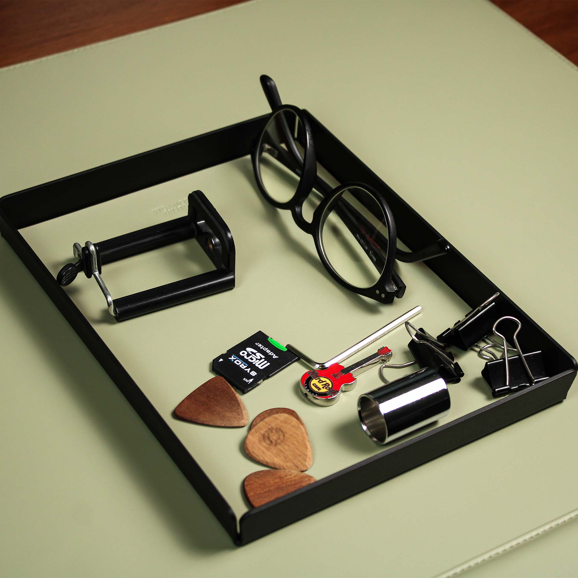 Minimalist desk setup featuring the sage-green valet tray with accessories