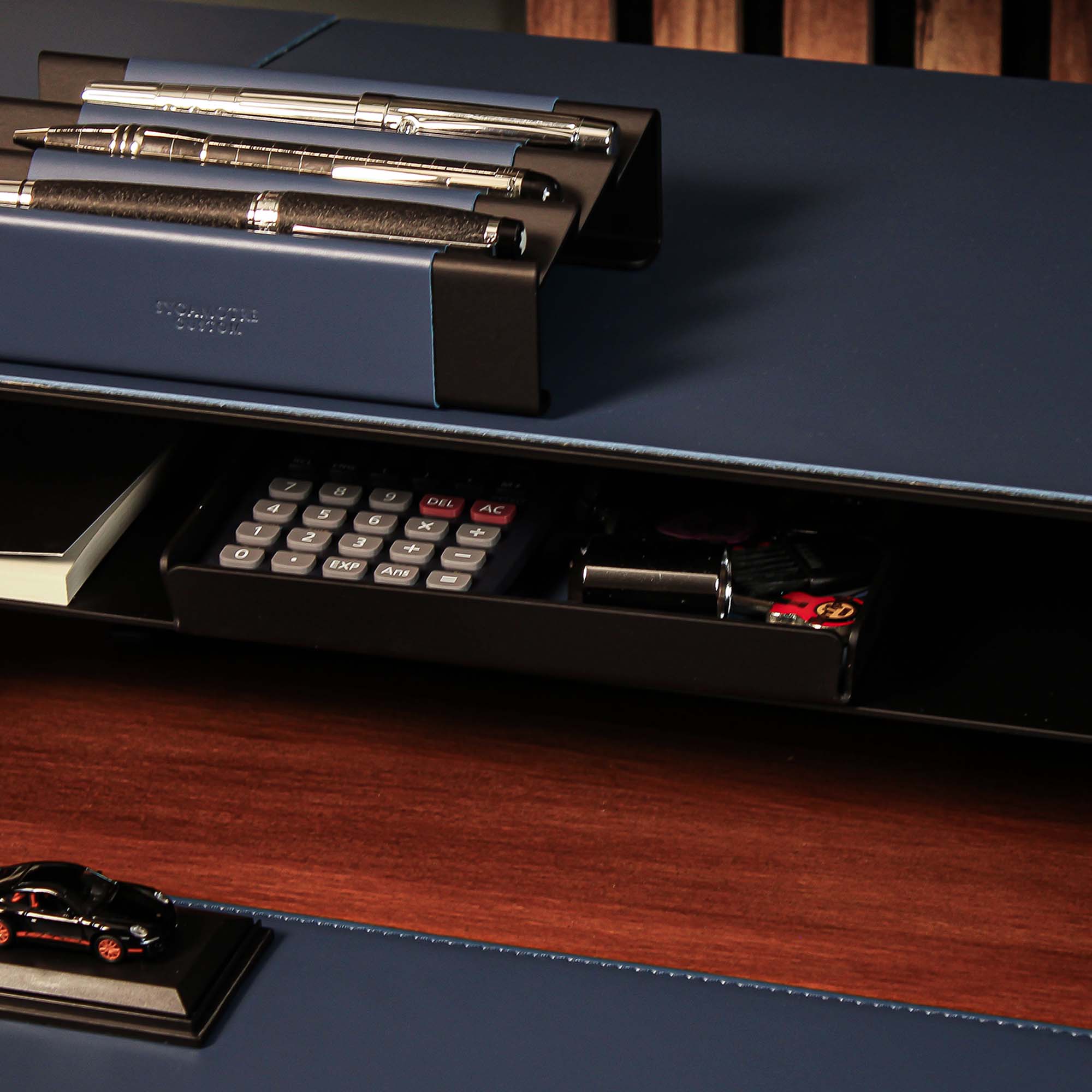Minimalist desk setup featuring the ocean-blue valet tray with accessories