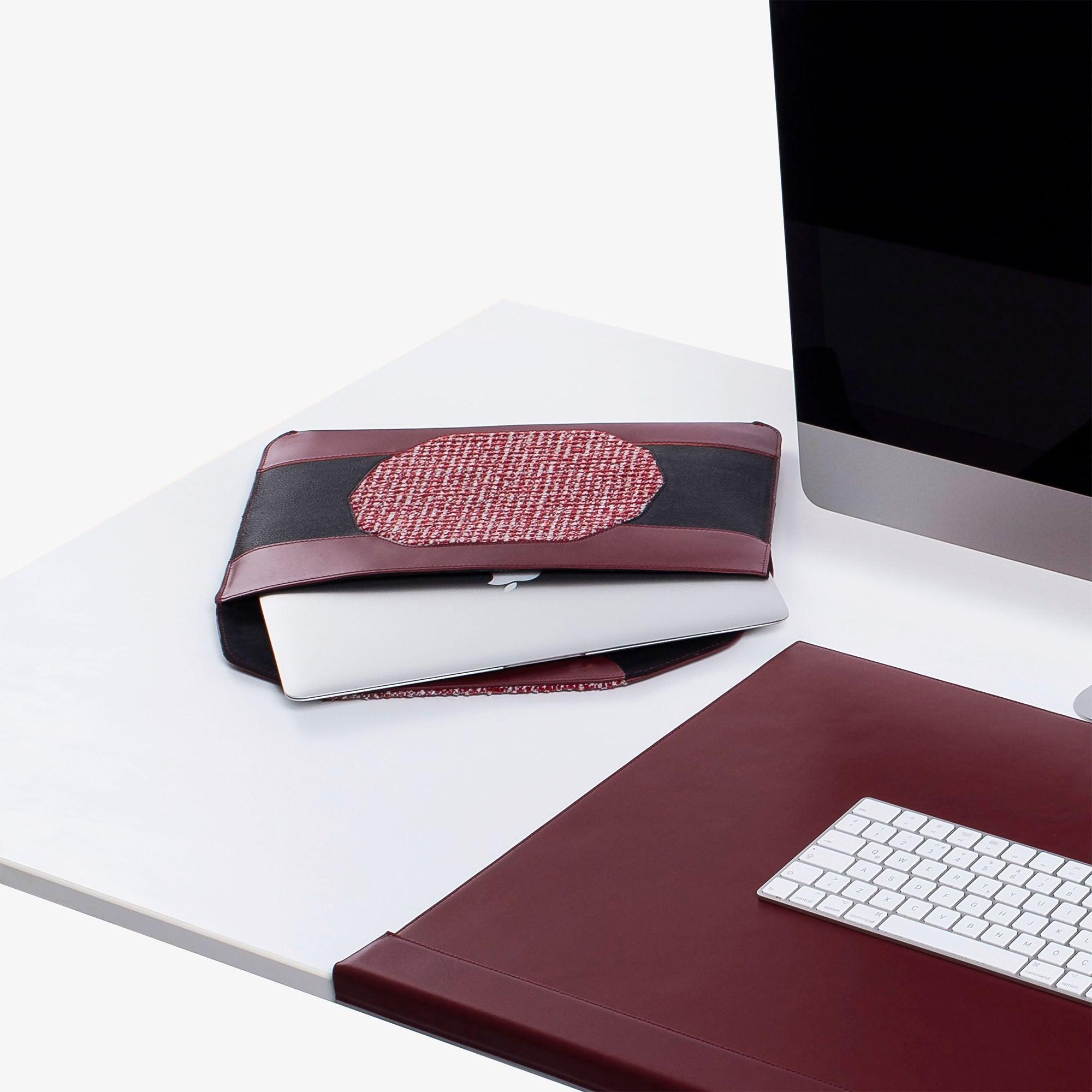Custom red leather MacBook sleeve on the desk