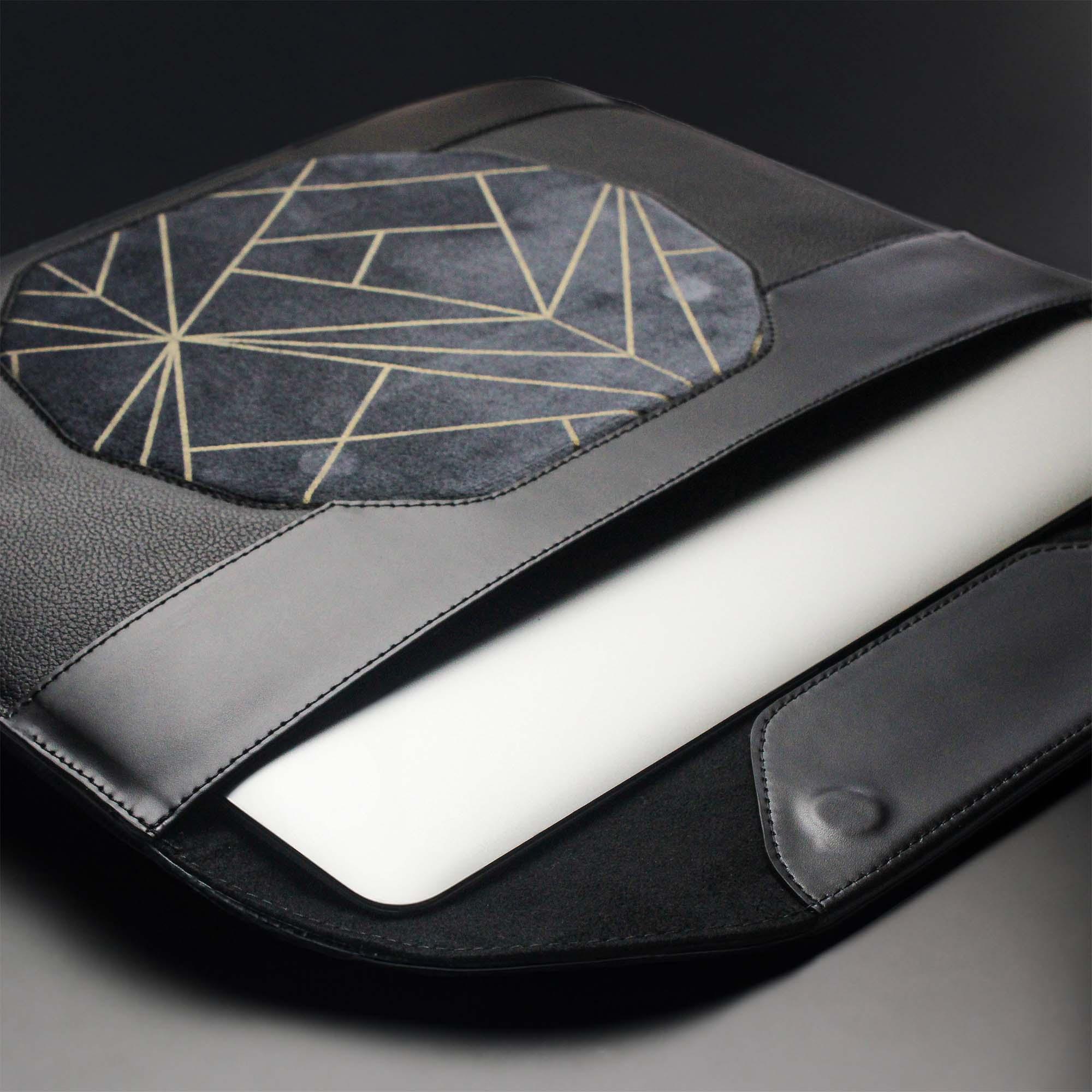 Personalized black leather MacBook sleeve on the desk