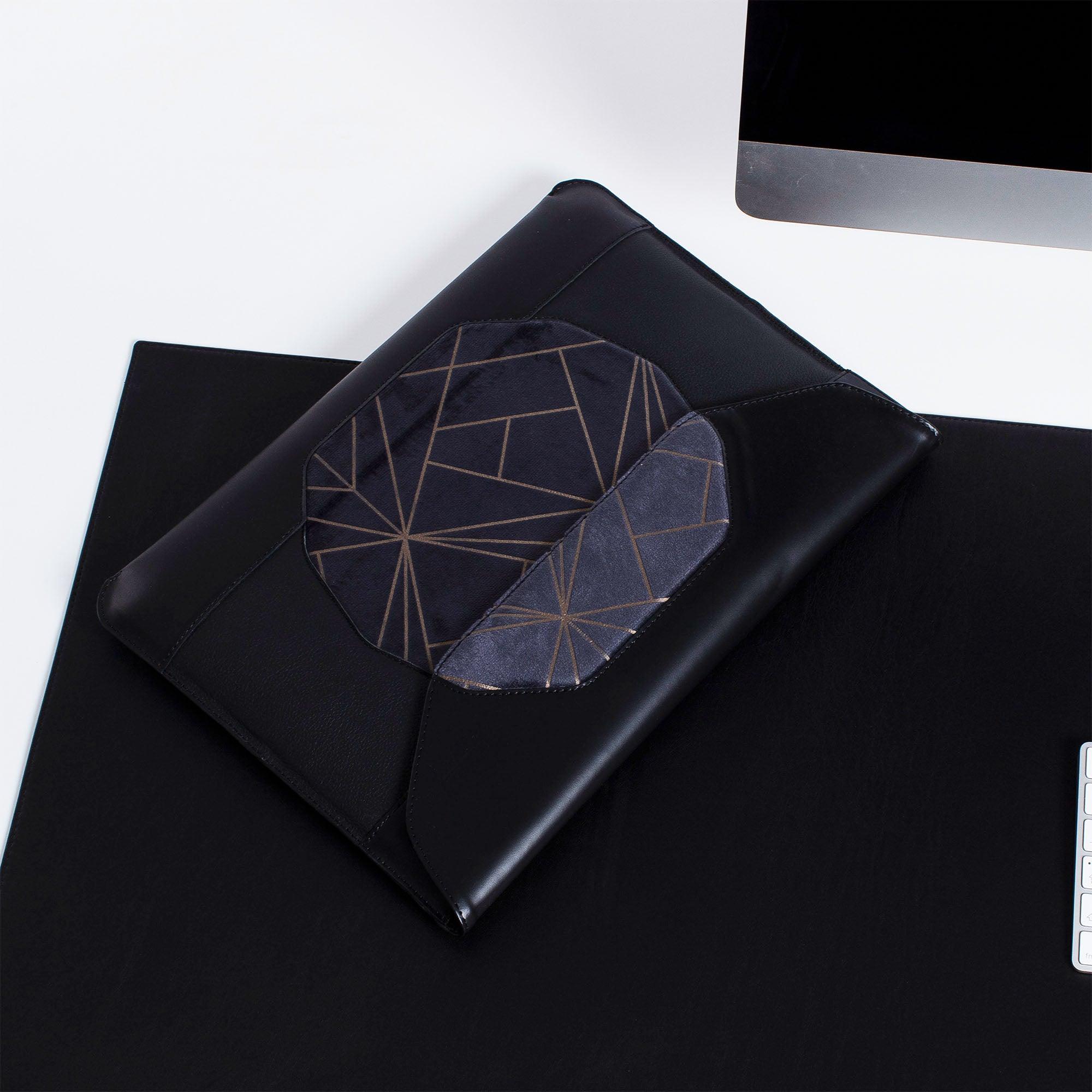 Personalized black leather MacBook sleeve on the desk