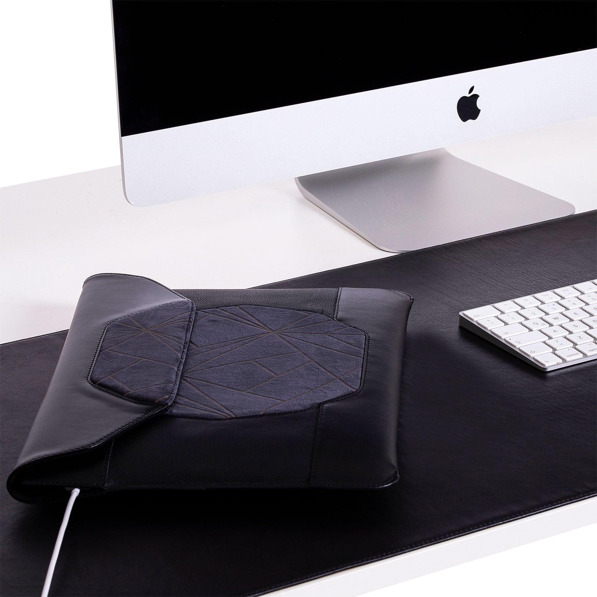 Custom black leather MacBook sleeve on the desk