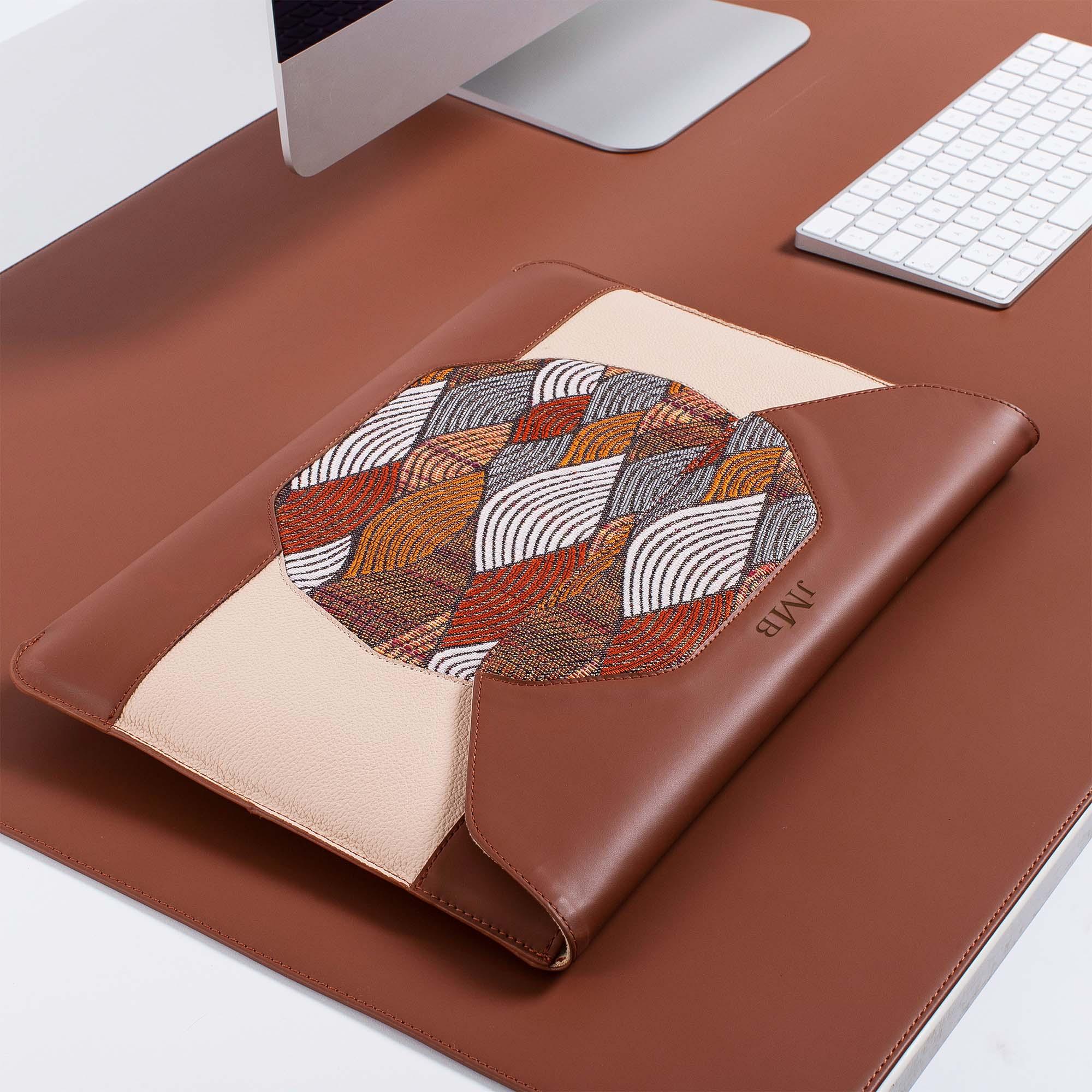 Personalized brown leather MacBook sleeve on the desk