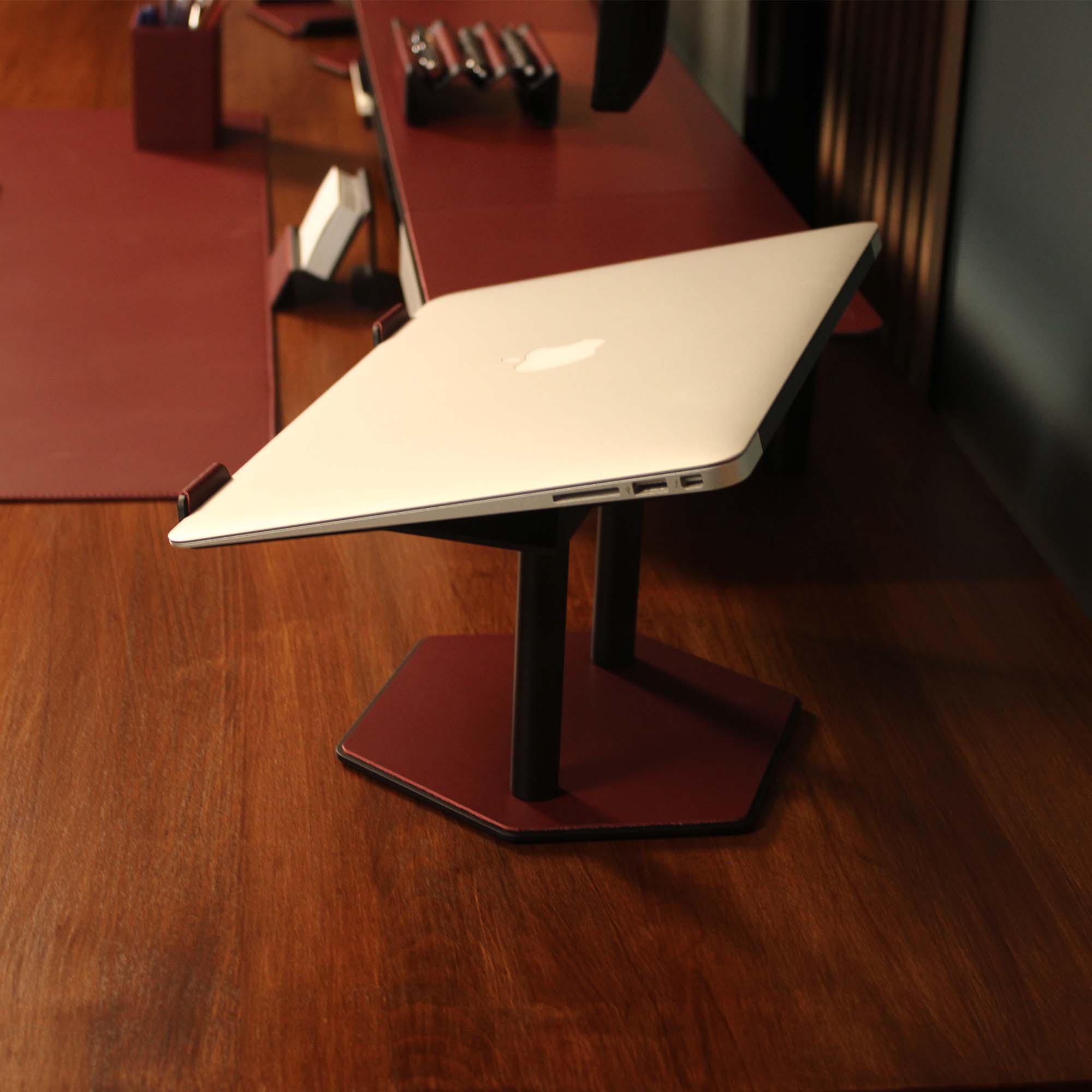 Close-up of the padded base of the burgundy laptop riser for desk protection