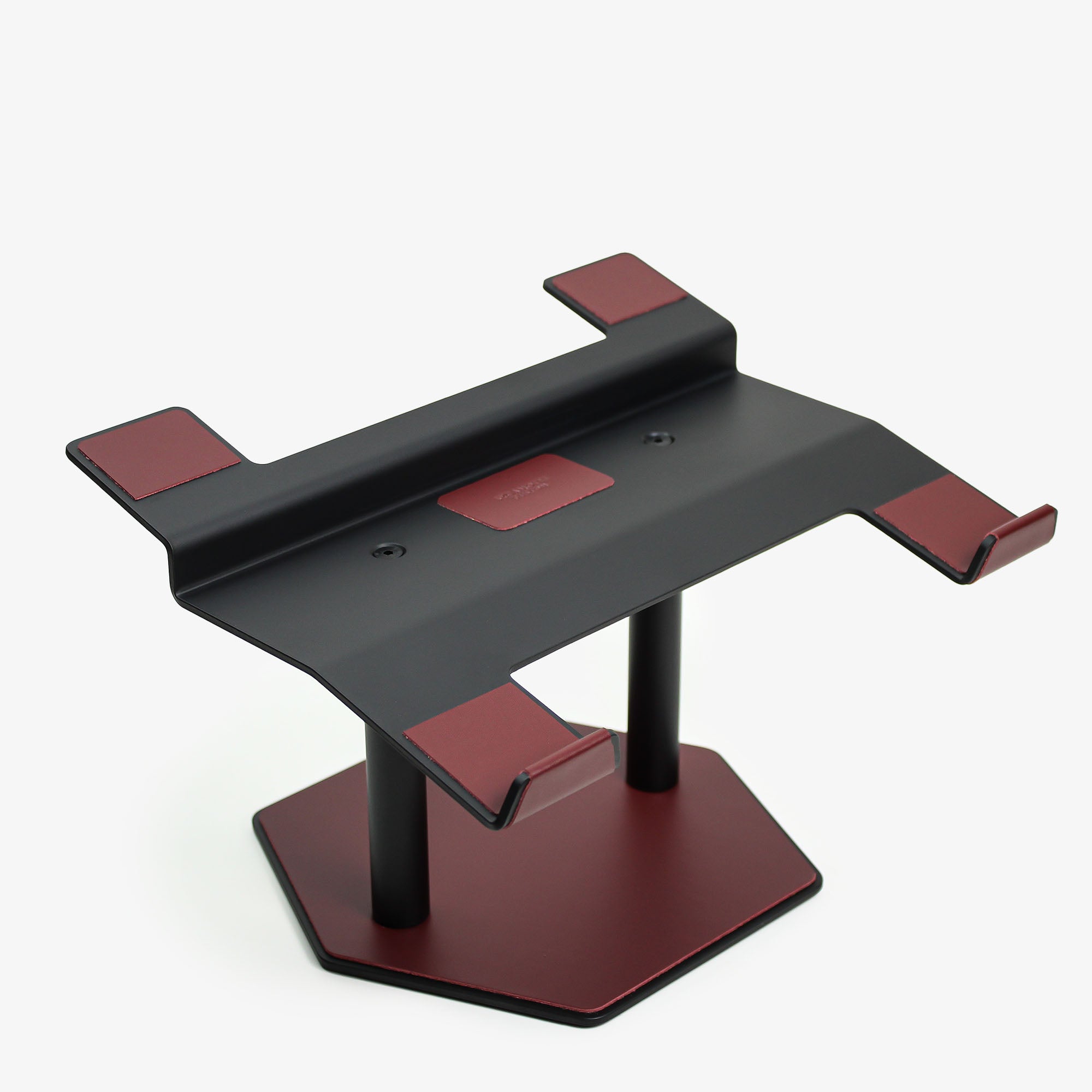 Front view of the burgundy leather and aluminum laptop riser on a desk #color_burgundy