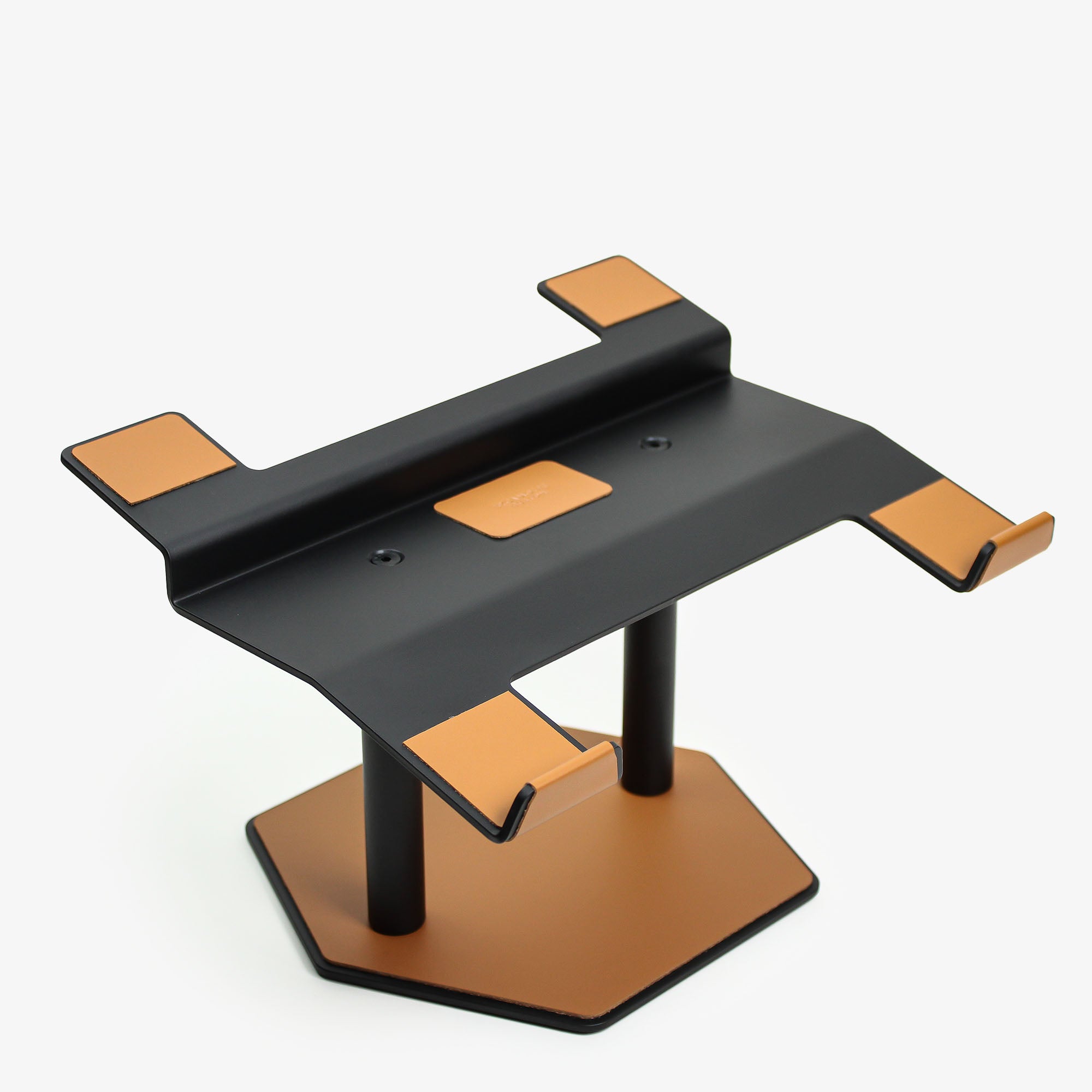 Front view of the cognac leather and aluminum laptop riser on a desk