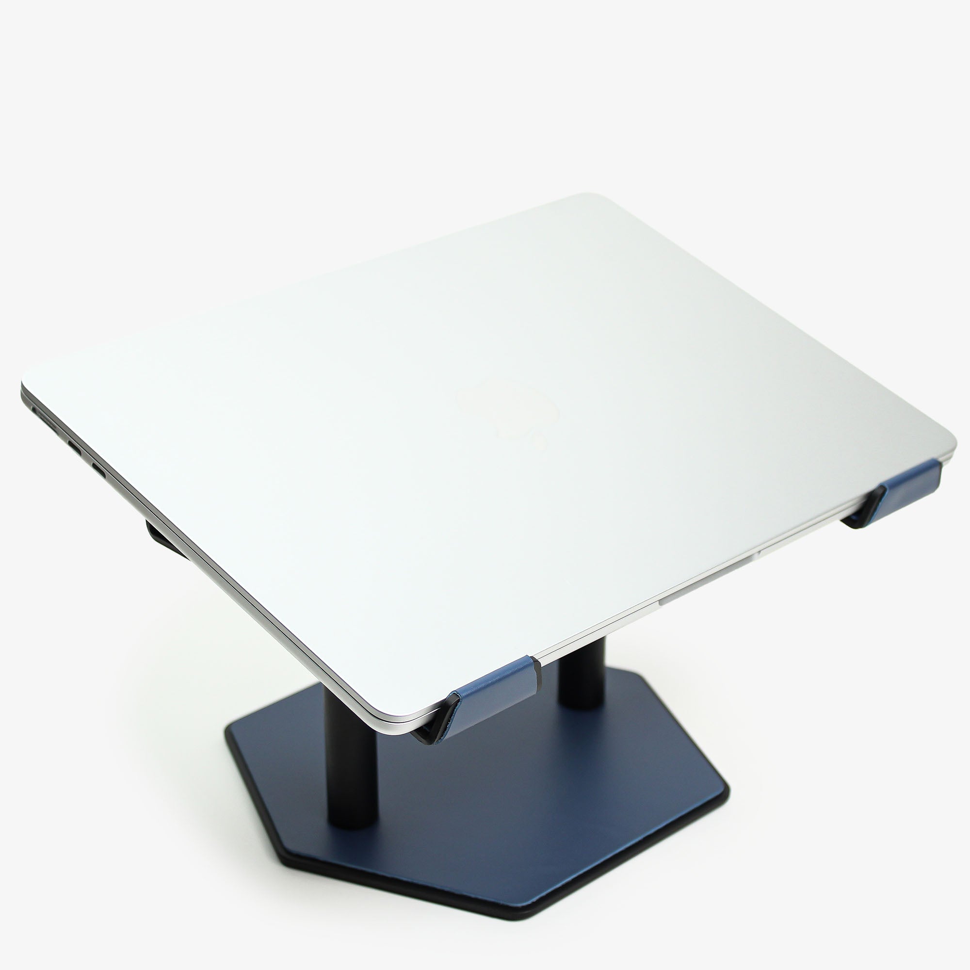 Side angle showing the ergonomic tilt of the ocean-blue laptop stand with macbook