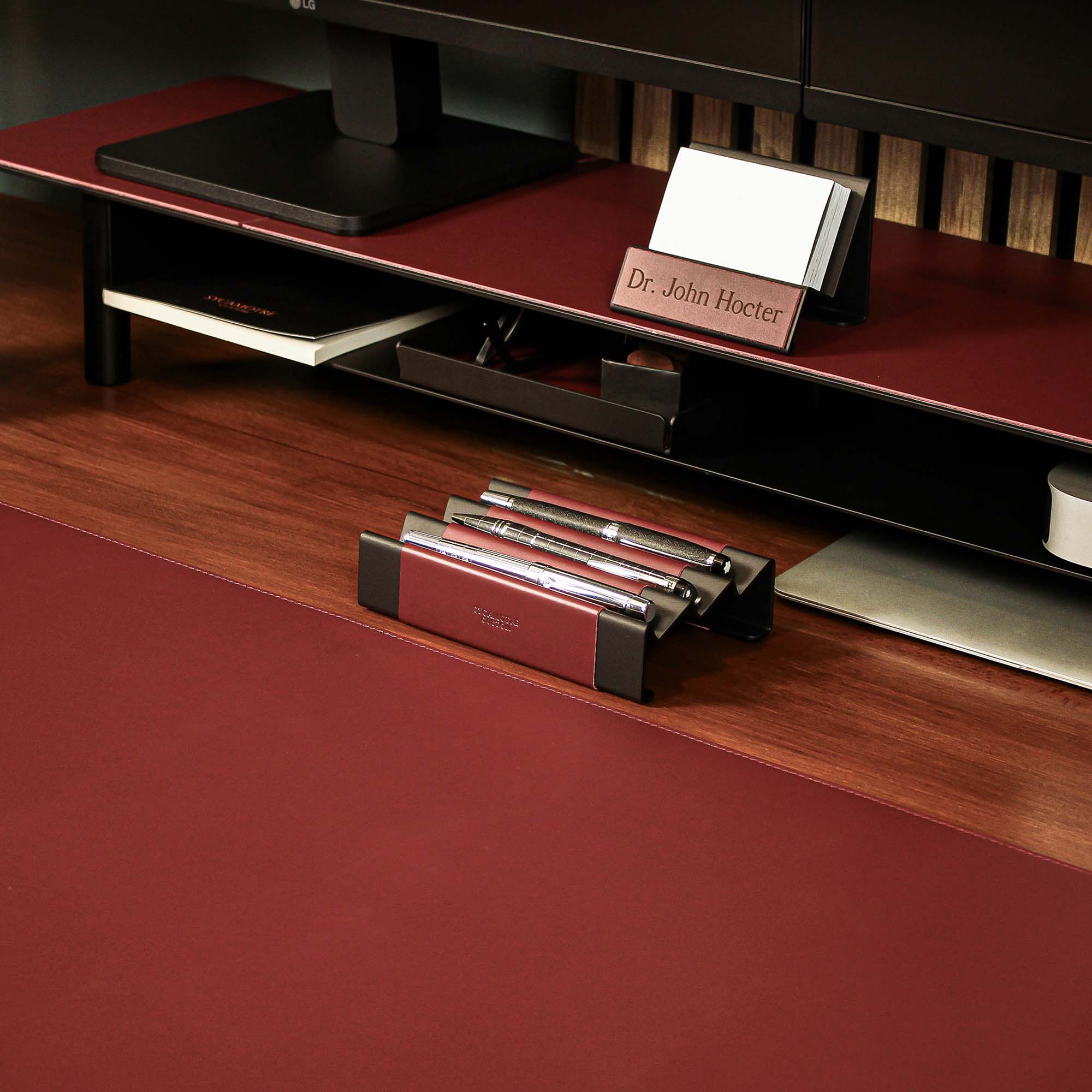 Minimalist workspace setup featuring the burgundy pen tray