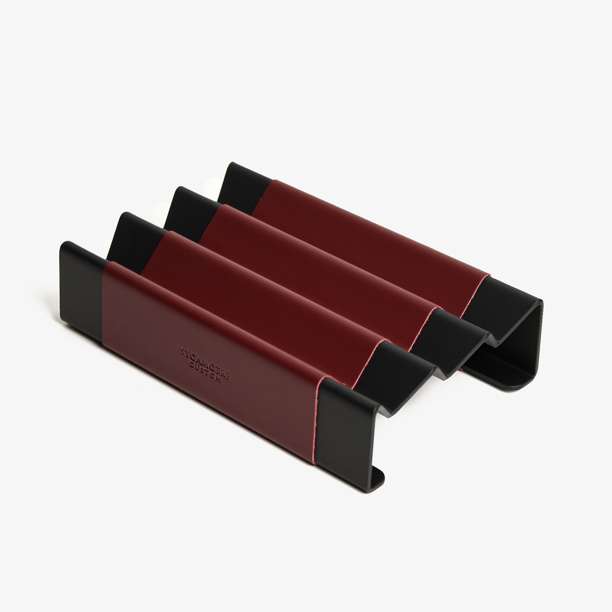 Side angle showing the depth and detail of the burgundy pen tray