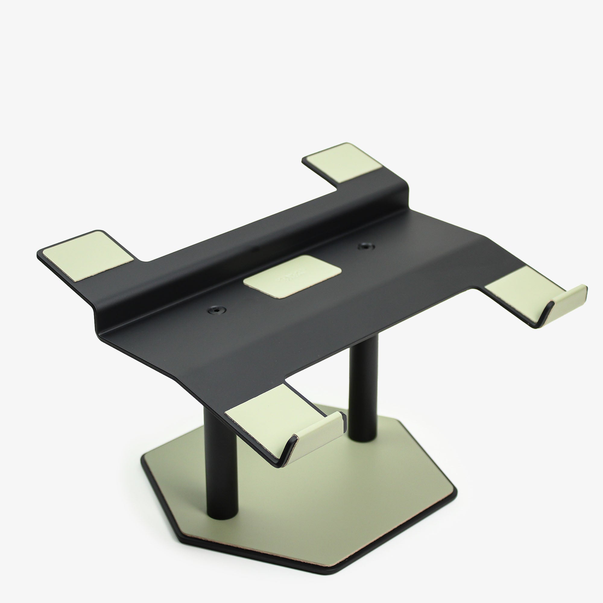 Front view of the sage-green leather and aluminum laptop riser on a desk