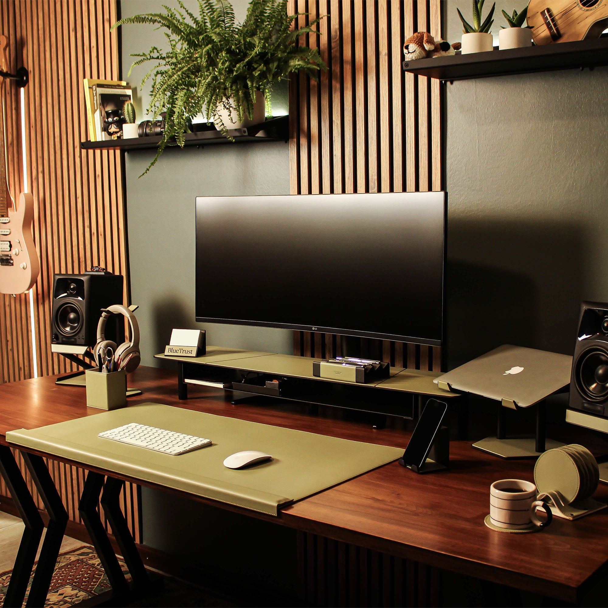 Lifestyle setup featuring the sage-green laptop riser with matching accessories