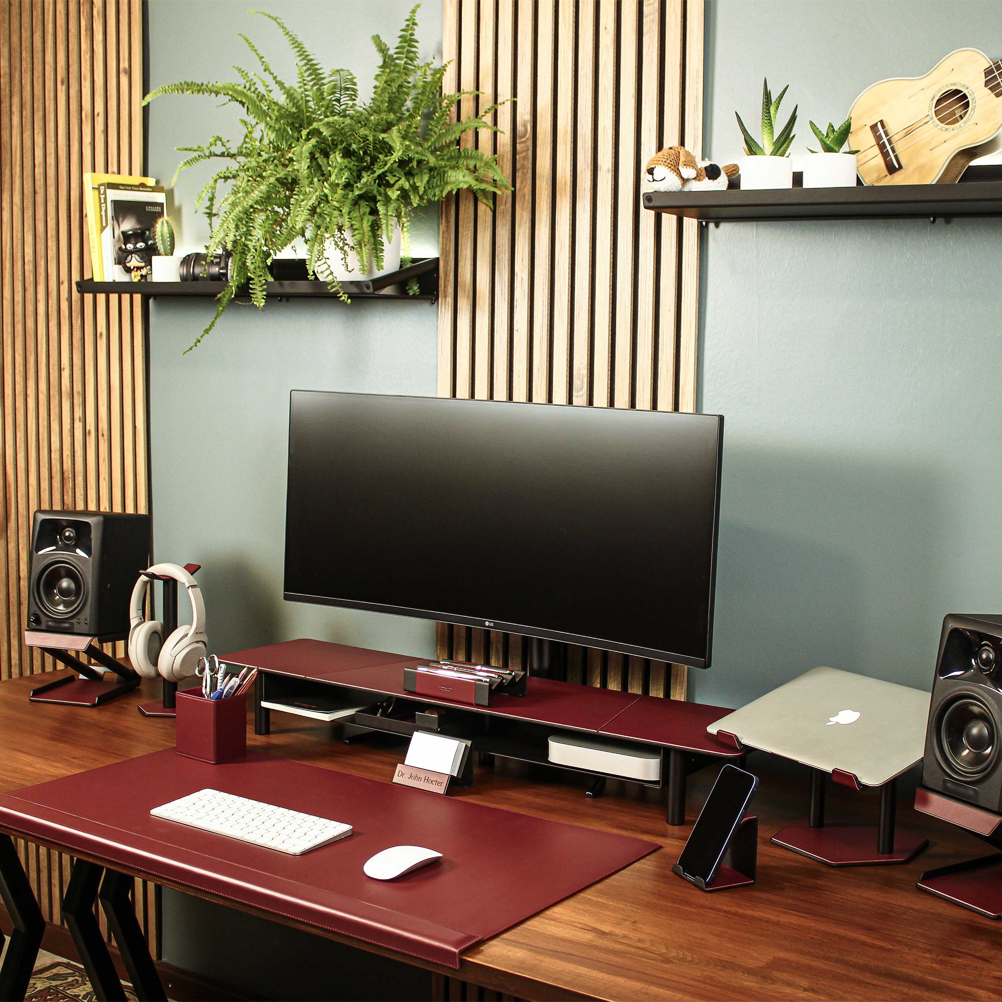 Lifestyle setup featuring the burgundy laptop riser with matching accessories