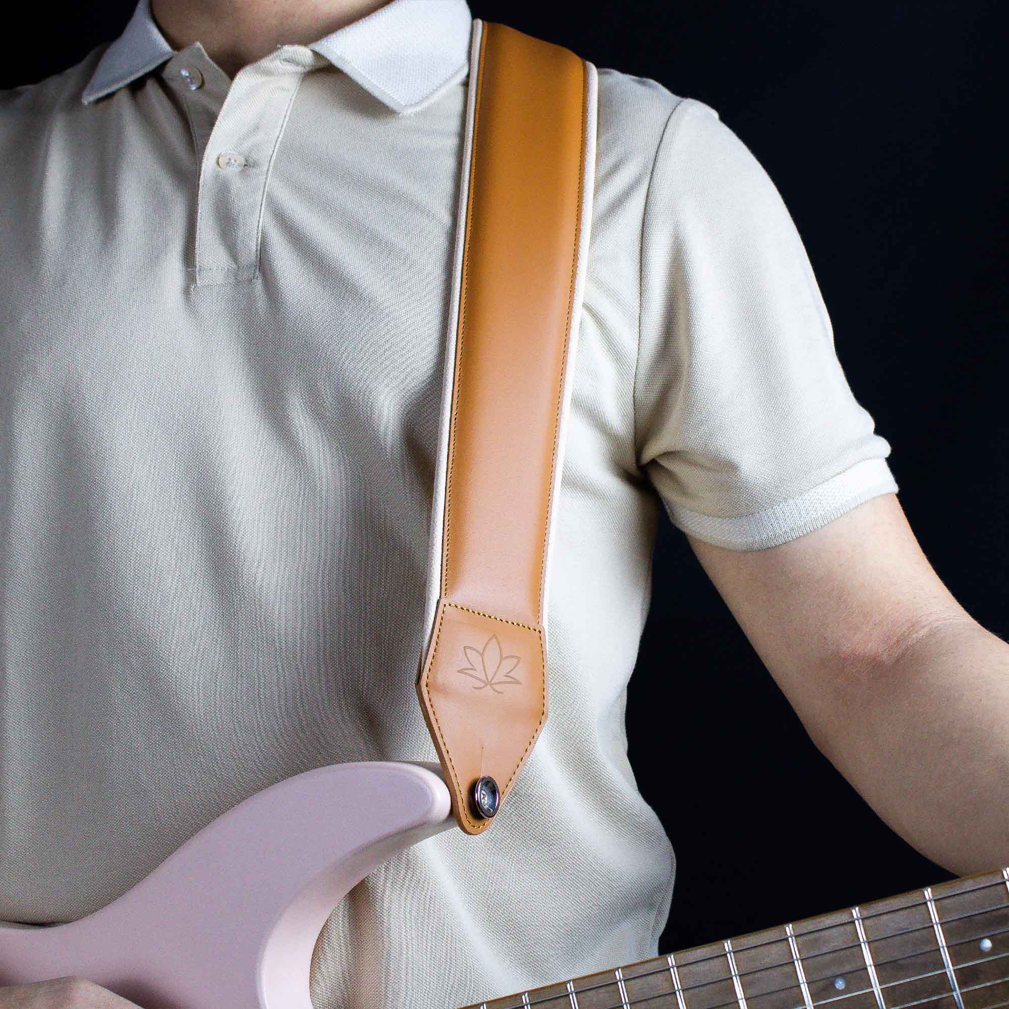 cognac leather guitar strap attached to electric guitar