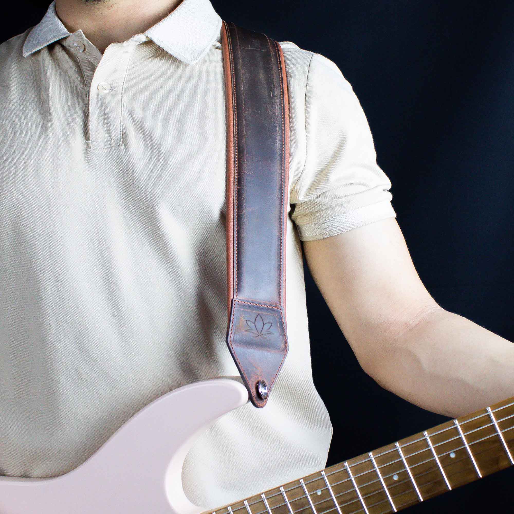 crazy chestnut leather guitar strap attached to electric guitar