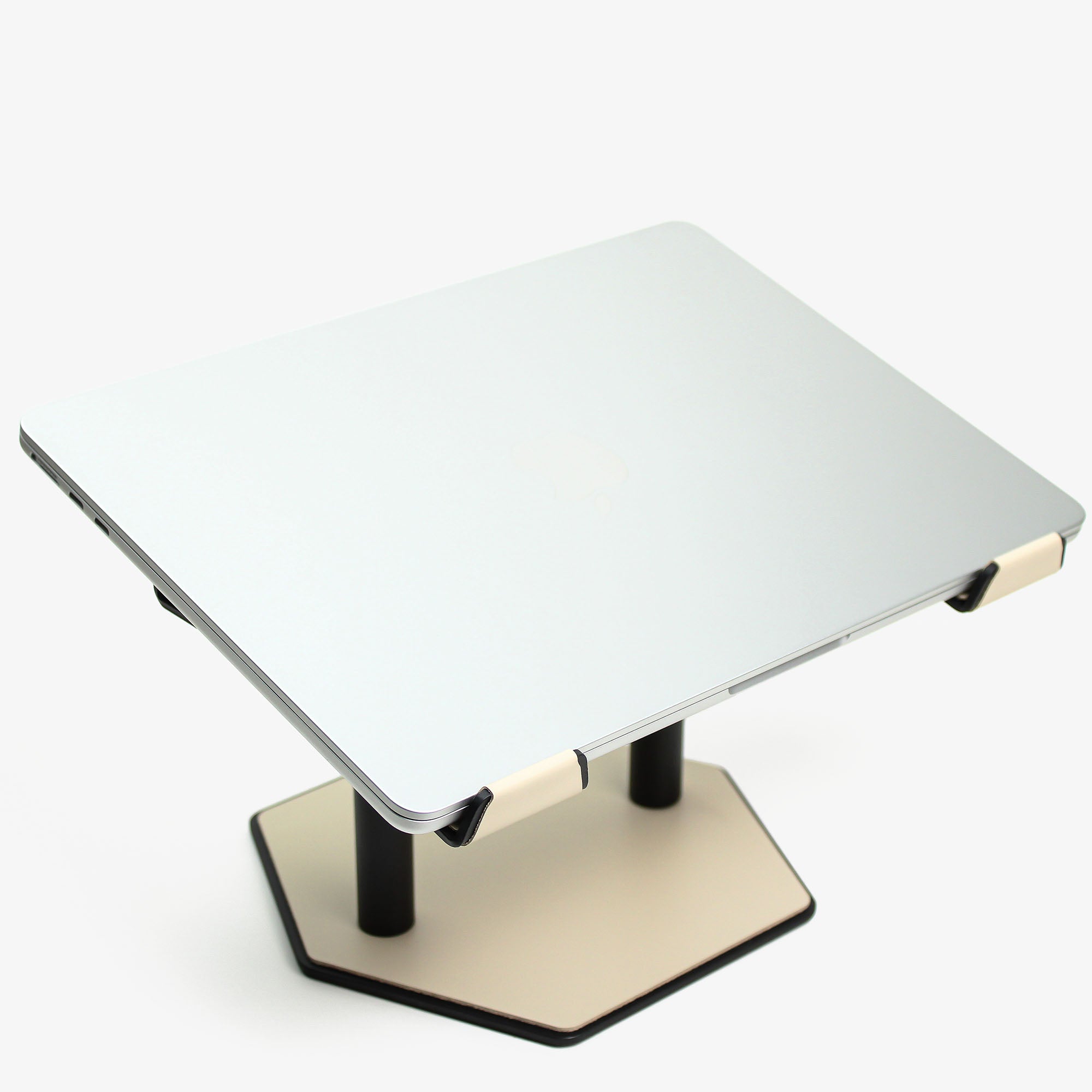 Side angle showing the ergonomic tilt of the beige laptop stand