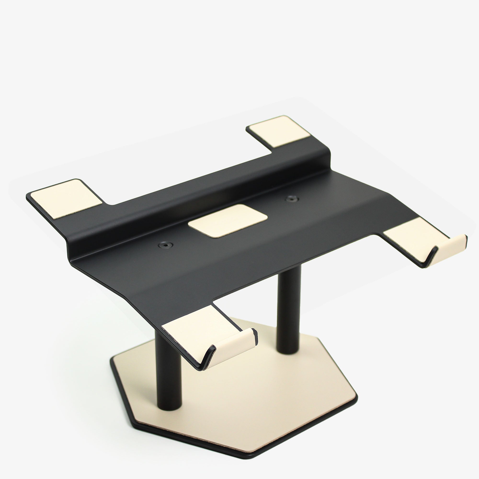 Front view of the beige leather and aluminum laptop riser on a desk