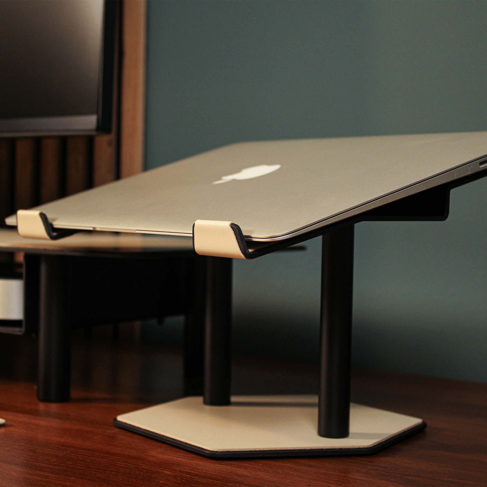 Close-up of the padded base of the beige laptop riser for desk protection