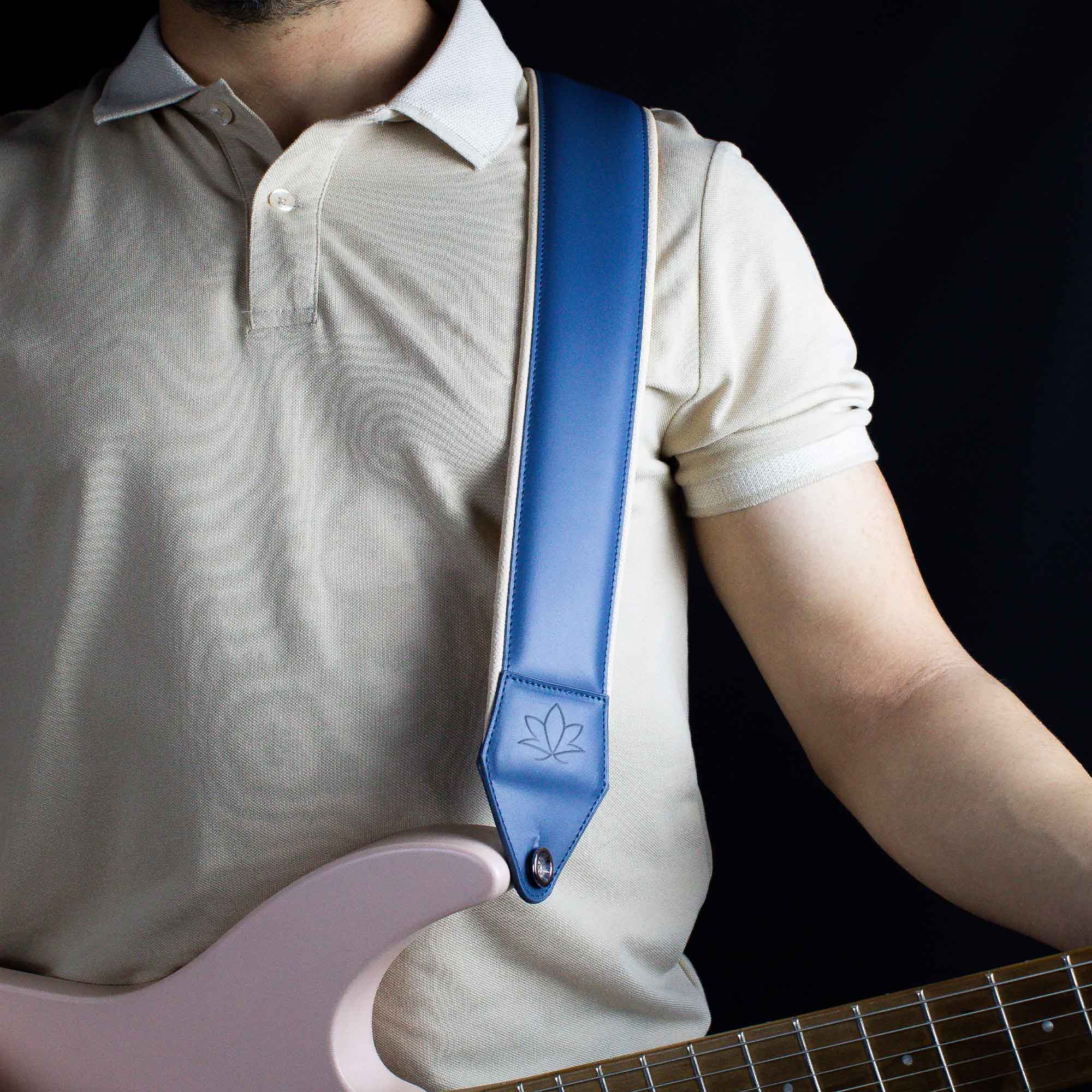 ocean blue leather guitar strap attached to electric guitar