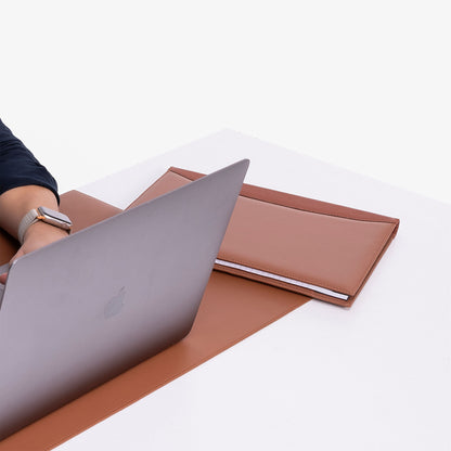 Brown Leather A4 padfolio on the desk near macbook 