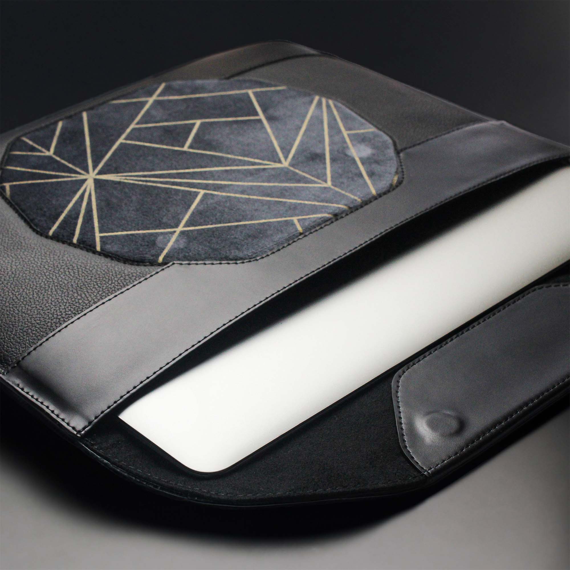 Personalized black leather MacBook sleeve on the desk 