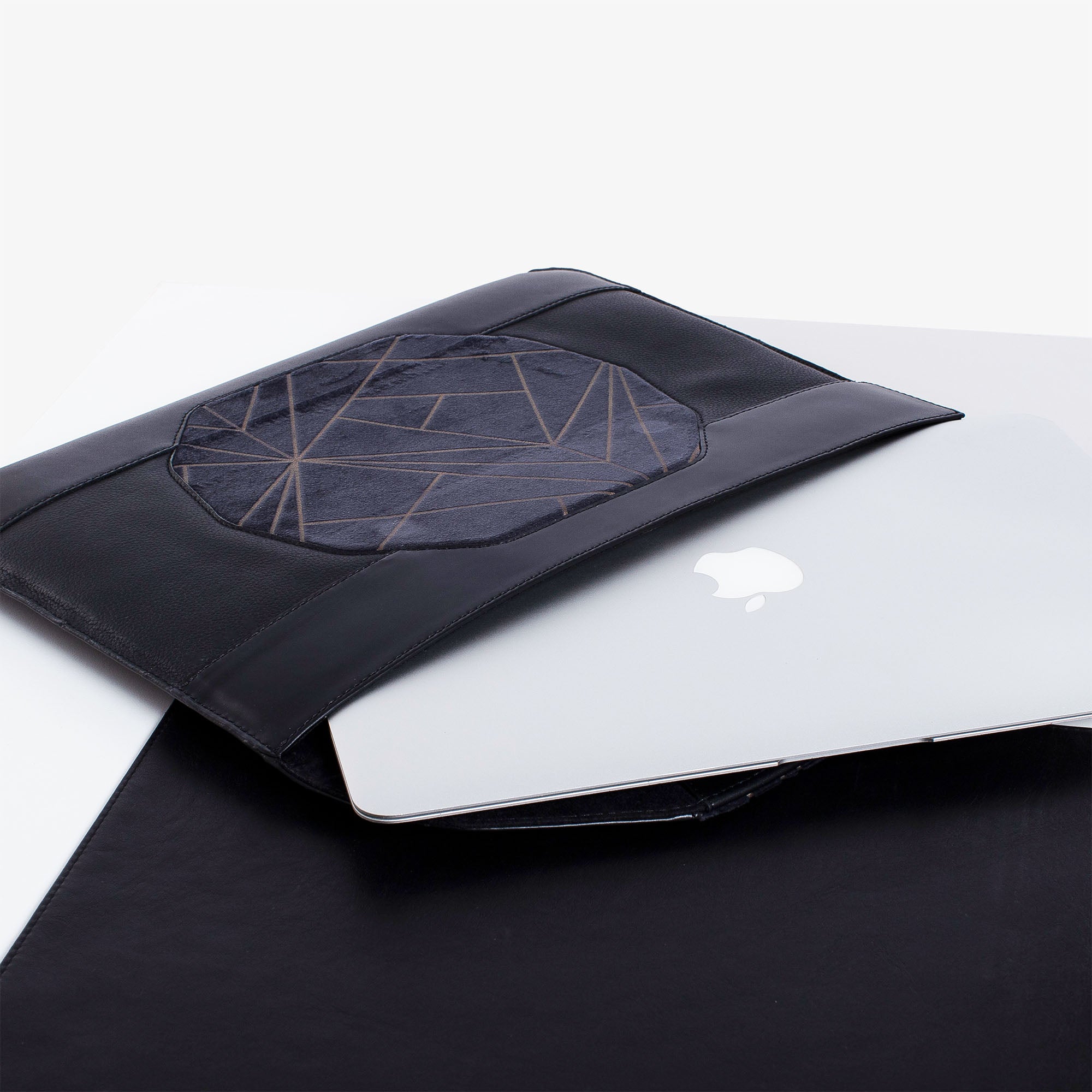 Personalized black leather MacBook sleeve on the desk 