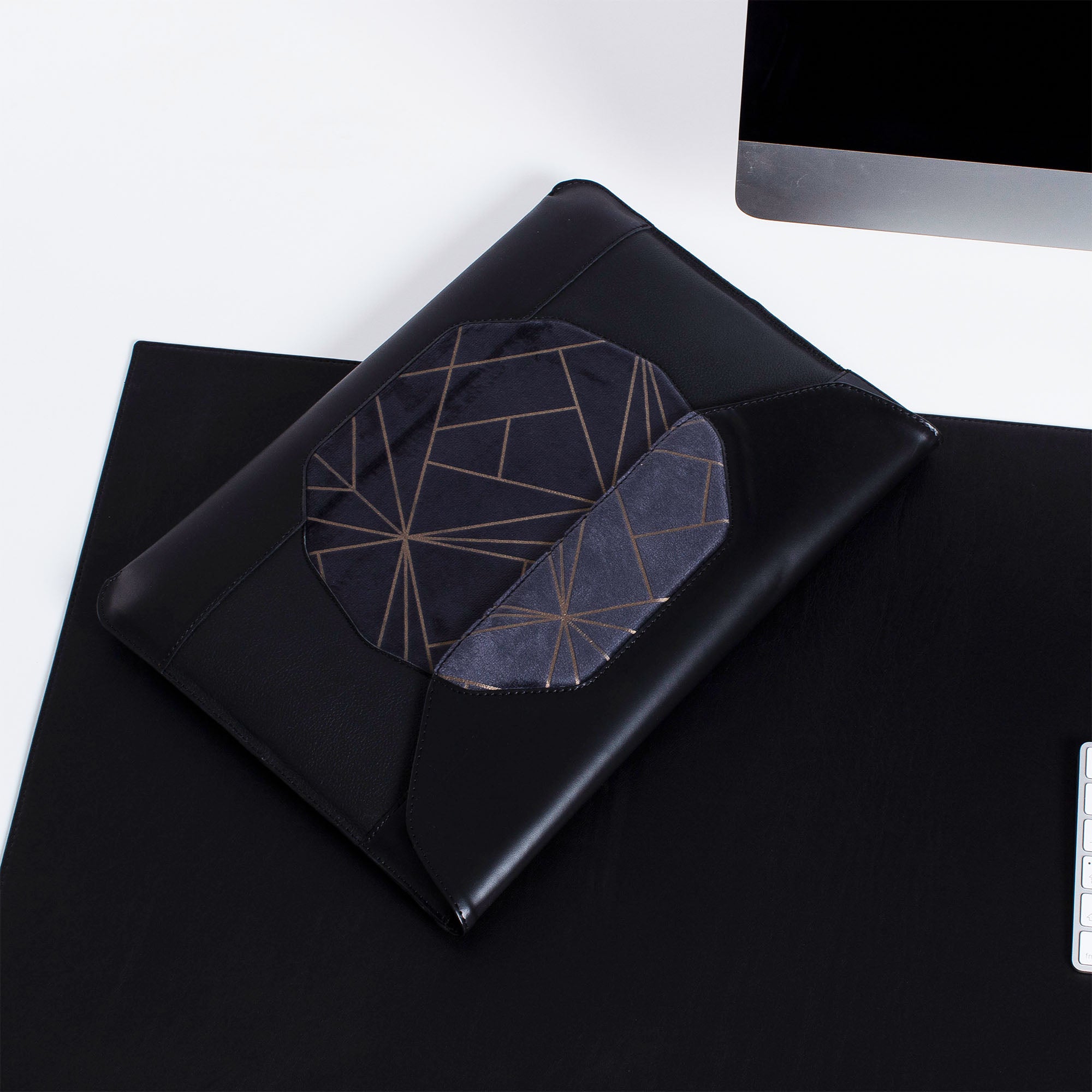 Personalized black leather MacBook sleeve on the desk 