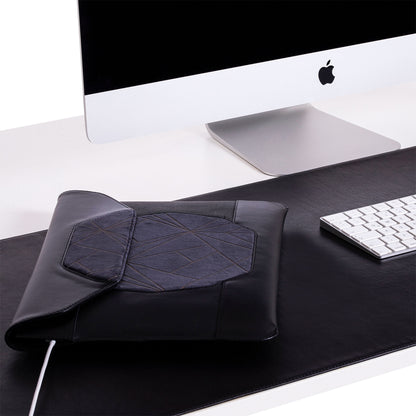 Custom black leather MacBook sleeve on the desk 