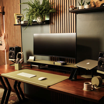 Lifestyle setup featuring the sage-green laptop riser with matching accessories 
