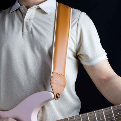 cognac leather guitar strap attached to electric guitar 