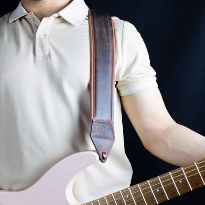 crazy chestnut leather guitar strap attached to electric guitar 